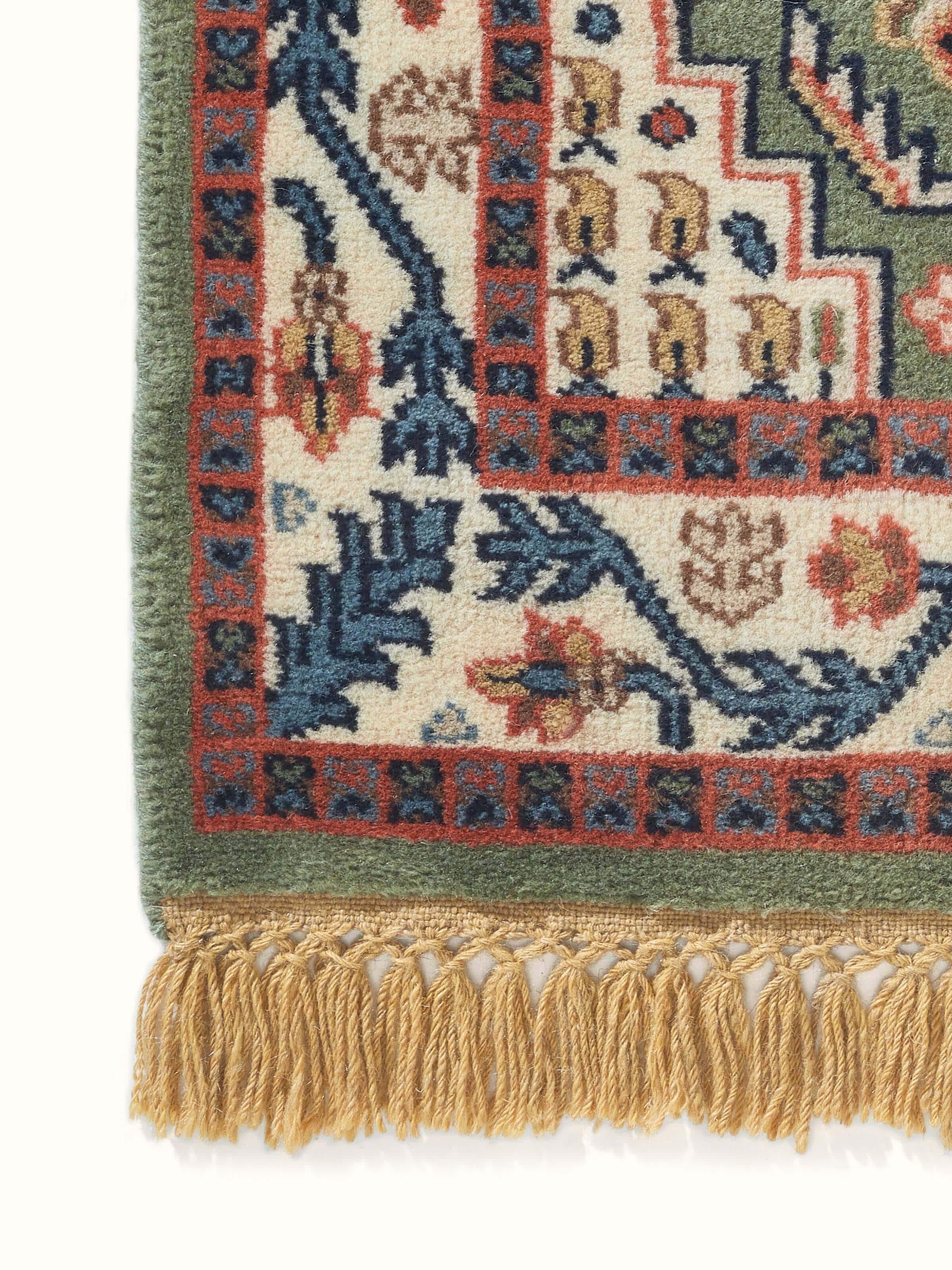 Detailed close-up of the Persian Kazak light green Gwalior wool hand-knotted runner, focusing on the wool fibers and design elements