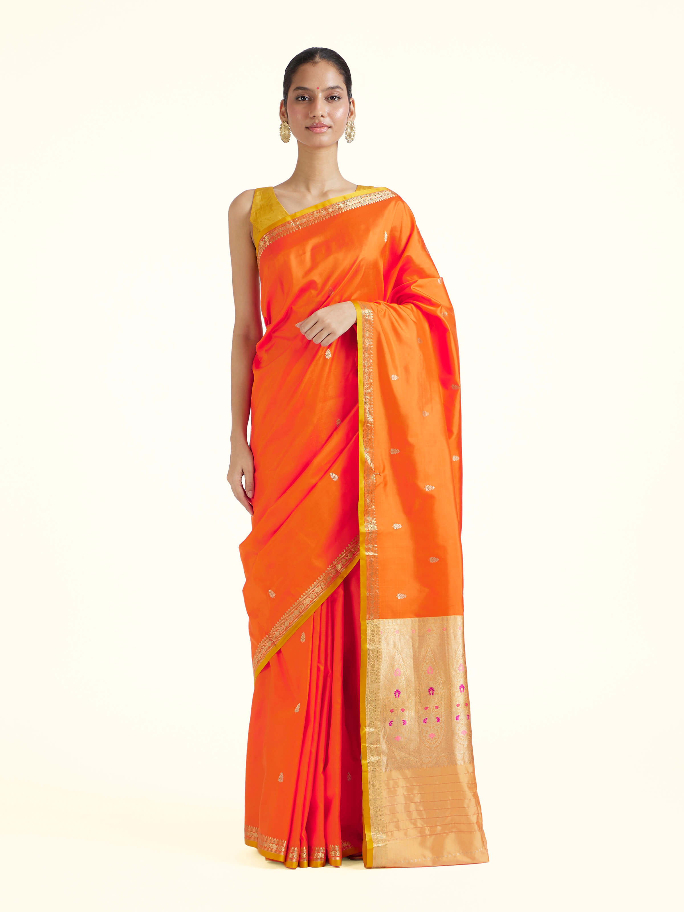 Front view of orange mulberry katan silk Banarasi saree with rich woven motifs