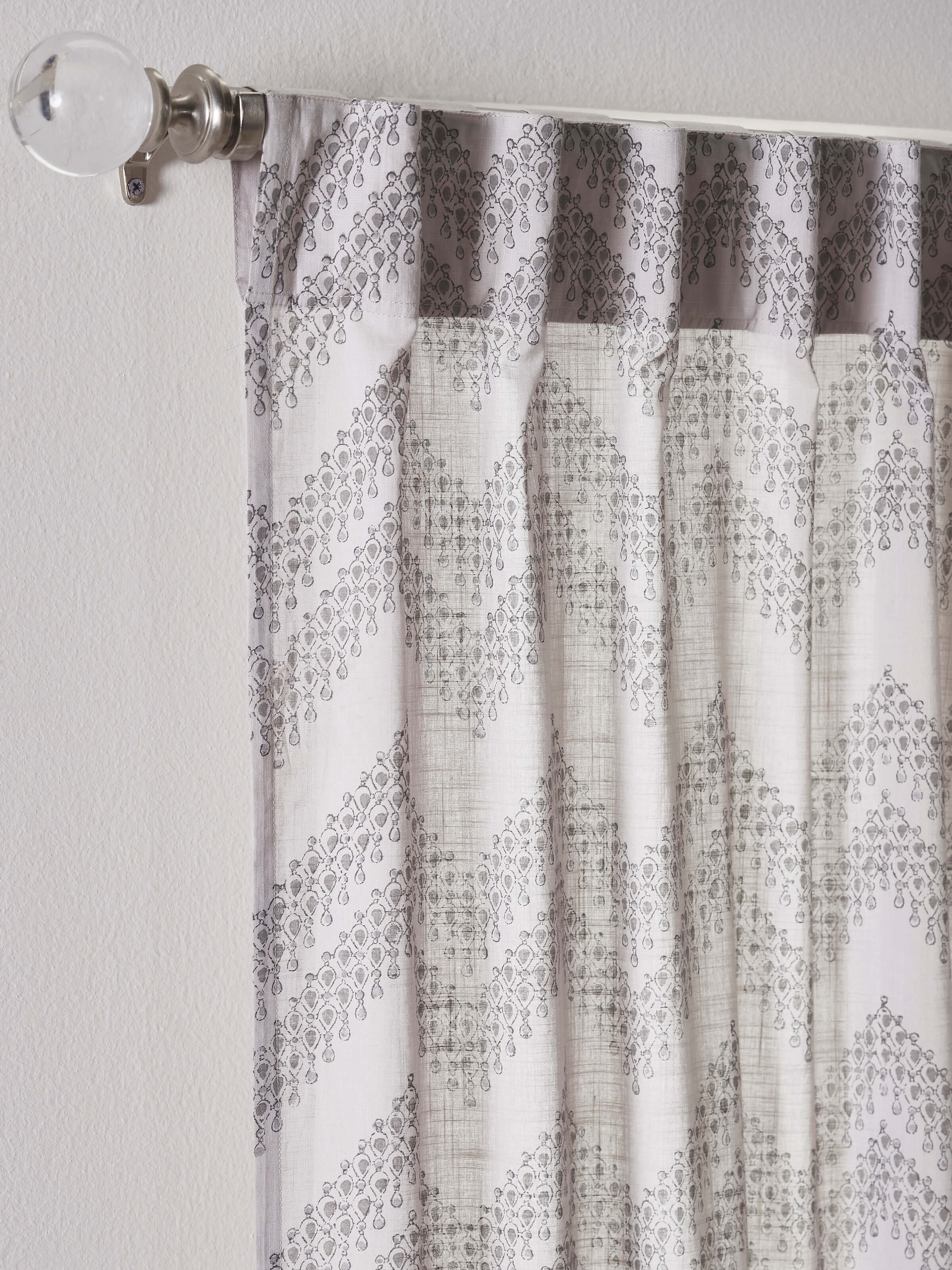 Front view of Rambagh curtain in light grey cotton featuring chevron Sanganeri block print