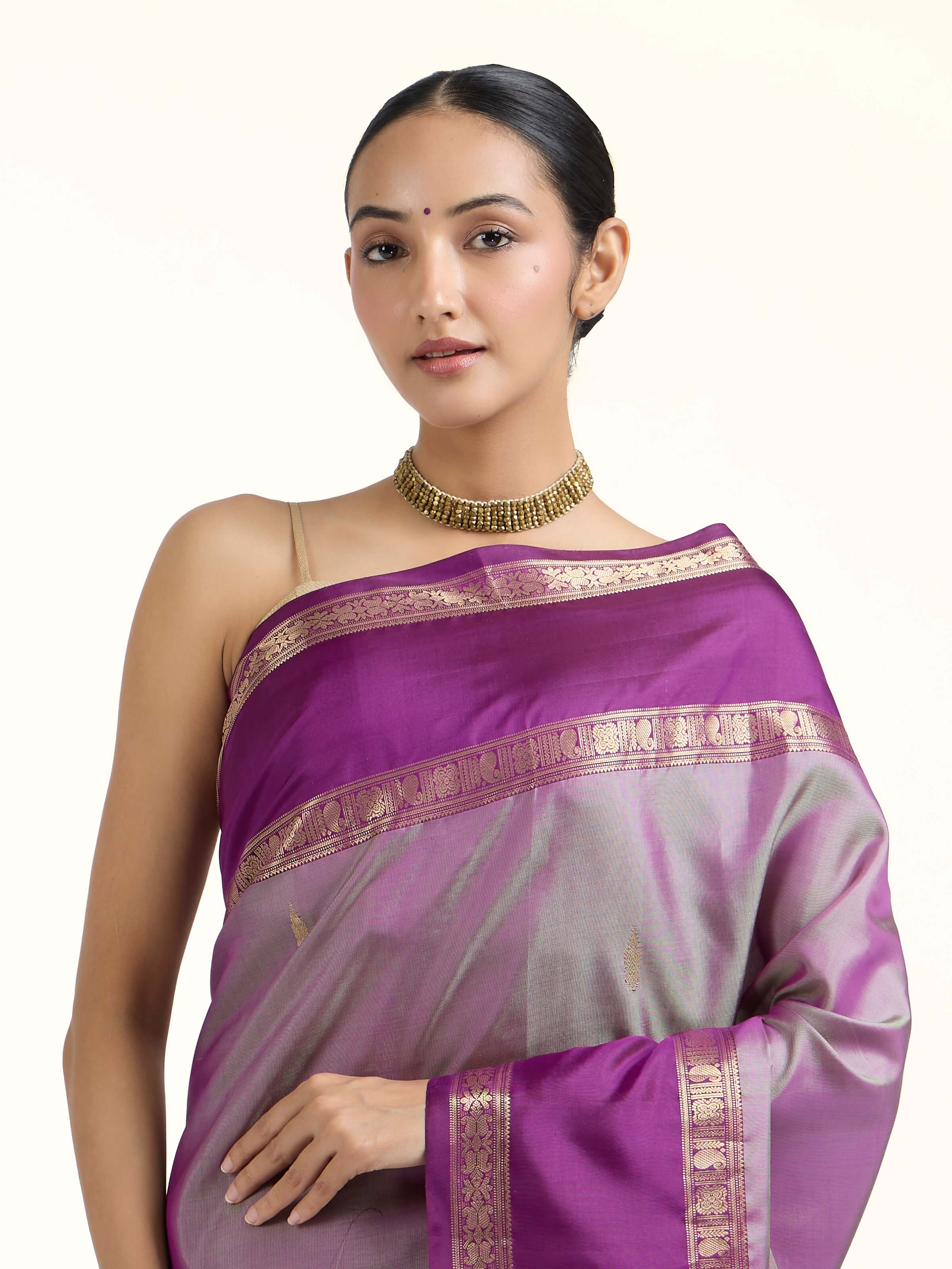 Angled view of purple silk Kancheepuram saree highlighting traditional weave and sheen