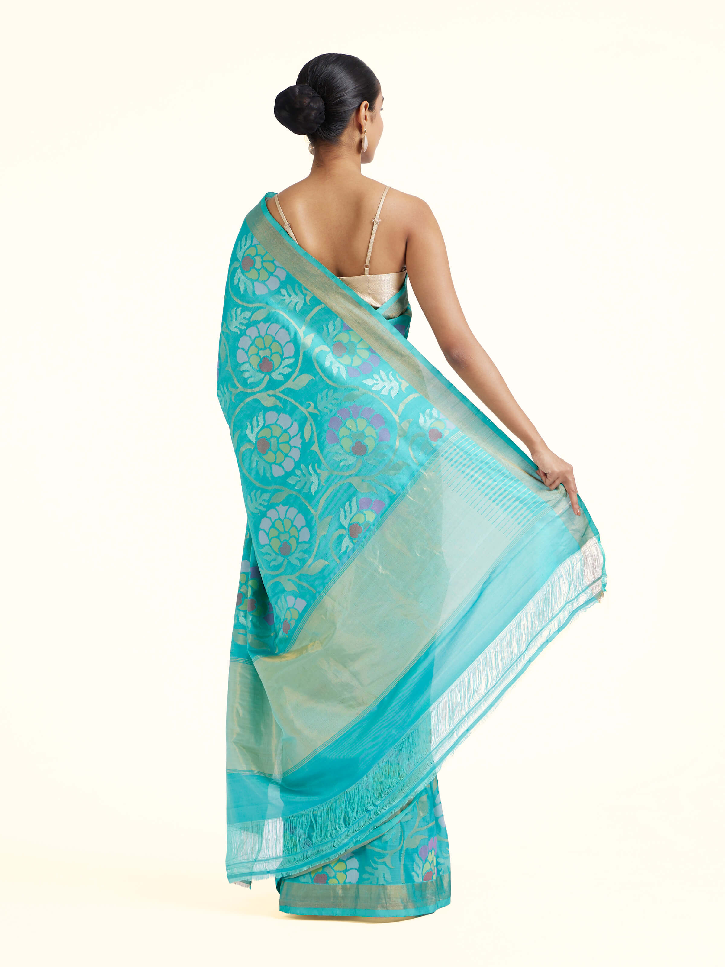 Back view of turquoise mulberry silk Uppada Jamdani saree displaying elegant pallu