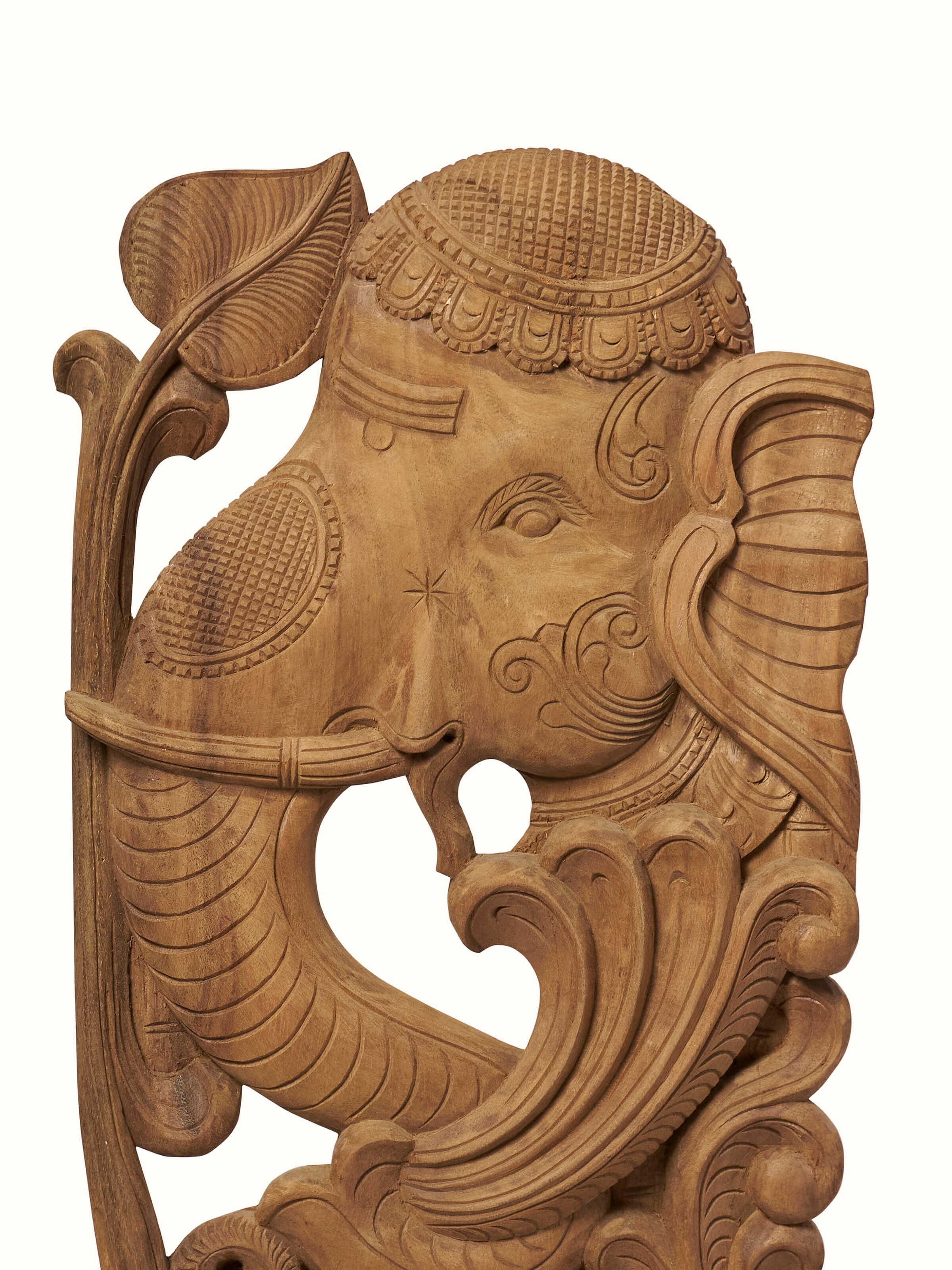 Detailed view of Tenali Carved Neem Wood Elephant Face Brackets Sculpture (2Pcs) by Swadesh emphasizing the detailed elephant carvings and wood finish.