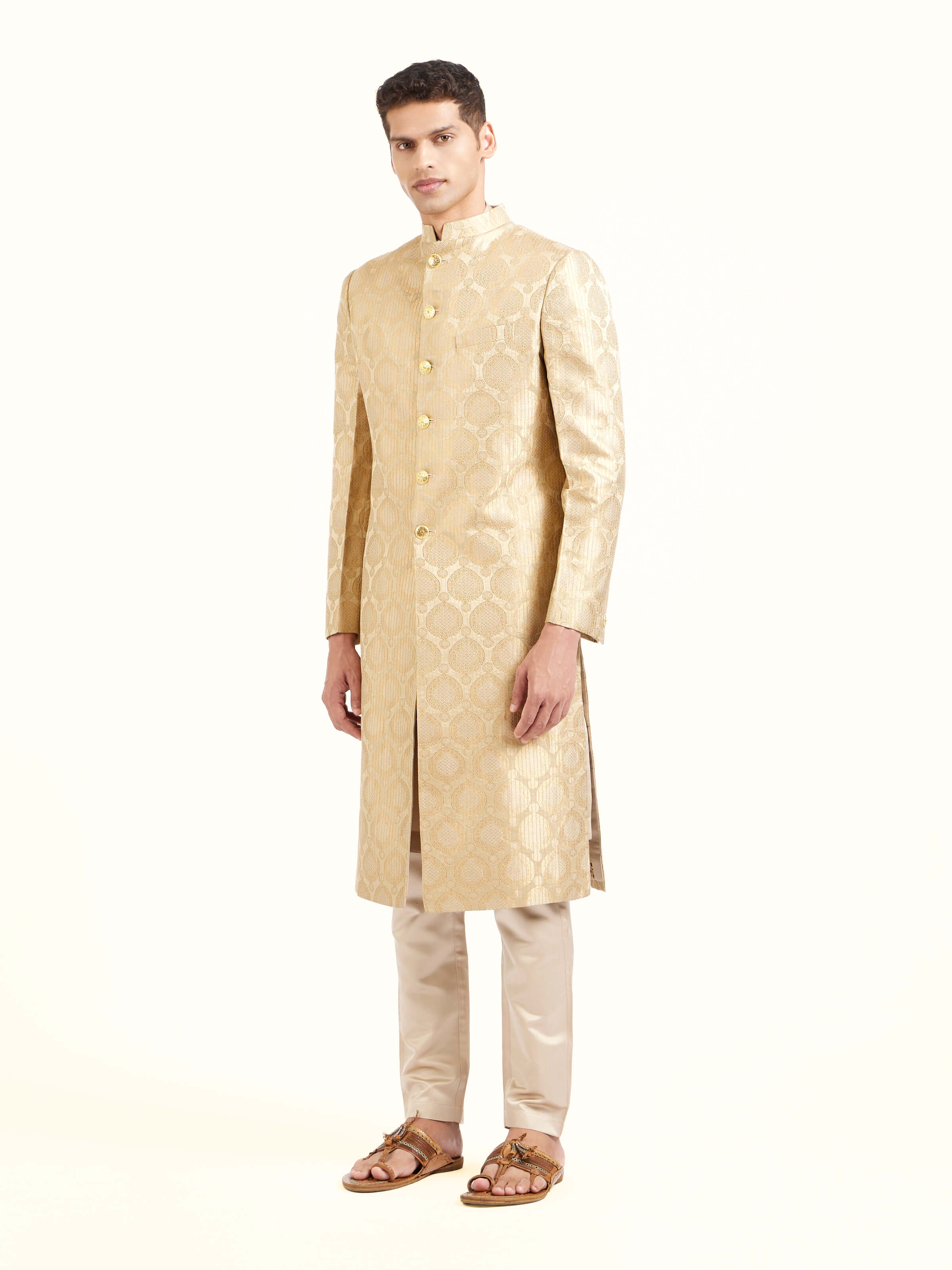 Side view of beige silk traditional butidar Banarasi handloom brocade men’s sherwani showcasing structured fit