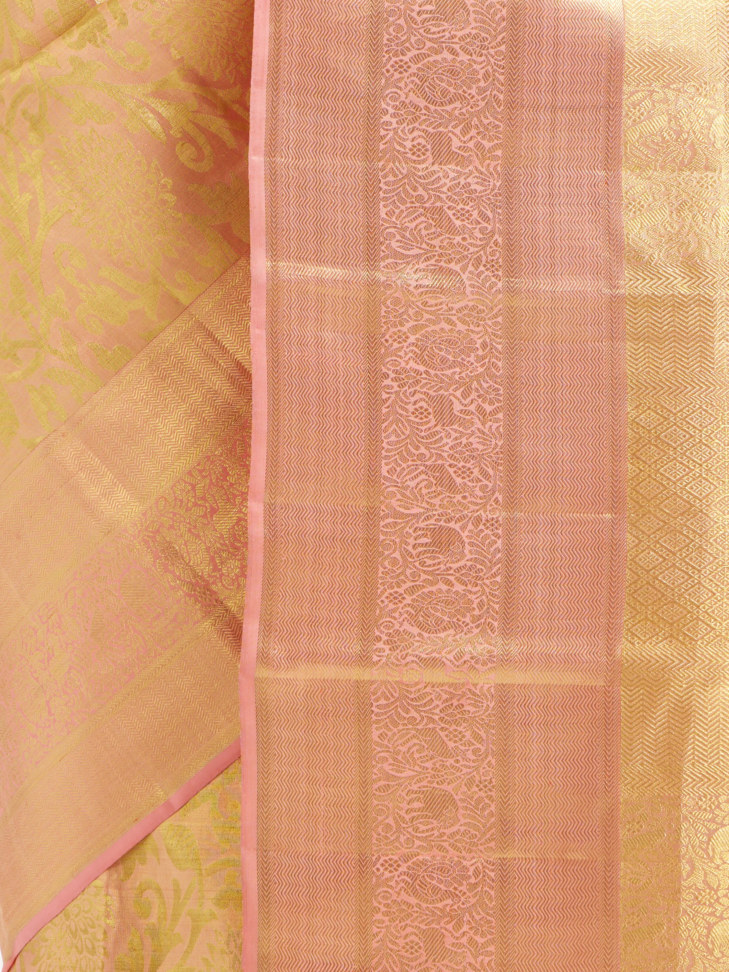 Detail view of peach silk Kancheepuram saree showing silk texture and zari craftsmanship