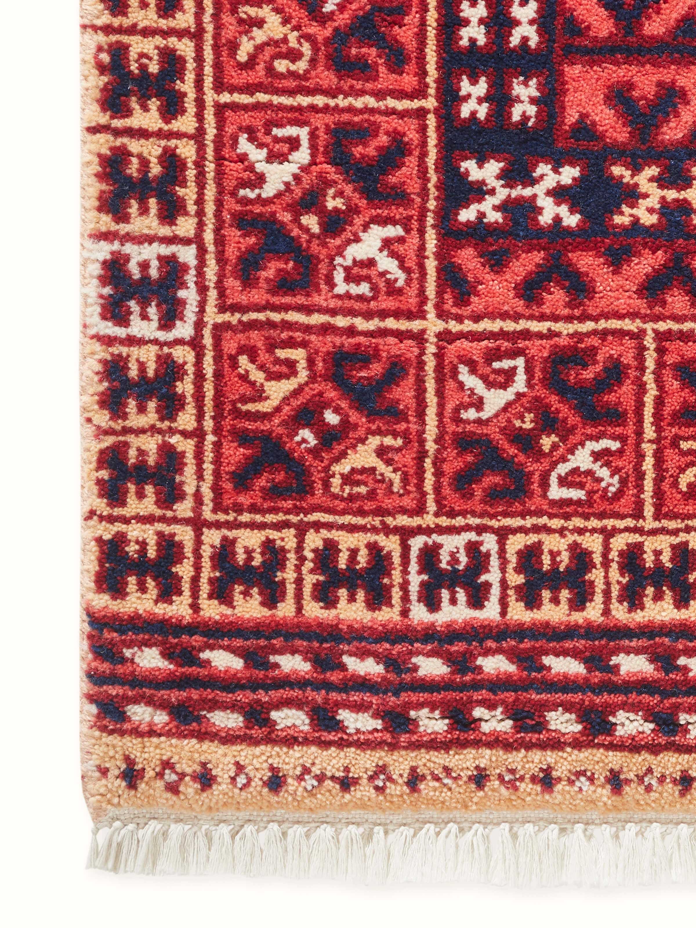 Detailed close-up emphasizing the hand-knotted wool texture and tribal patterns