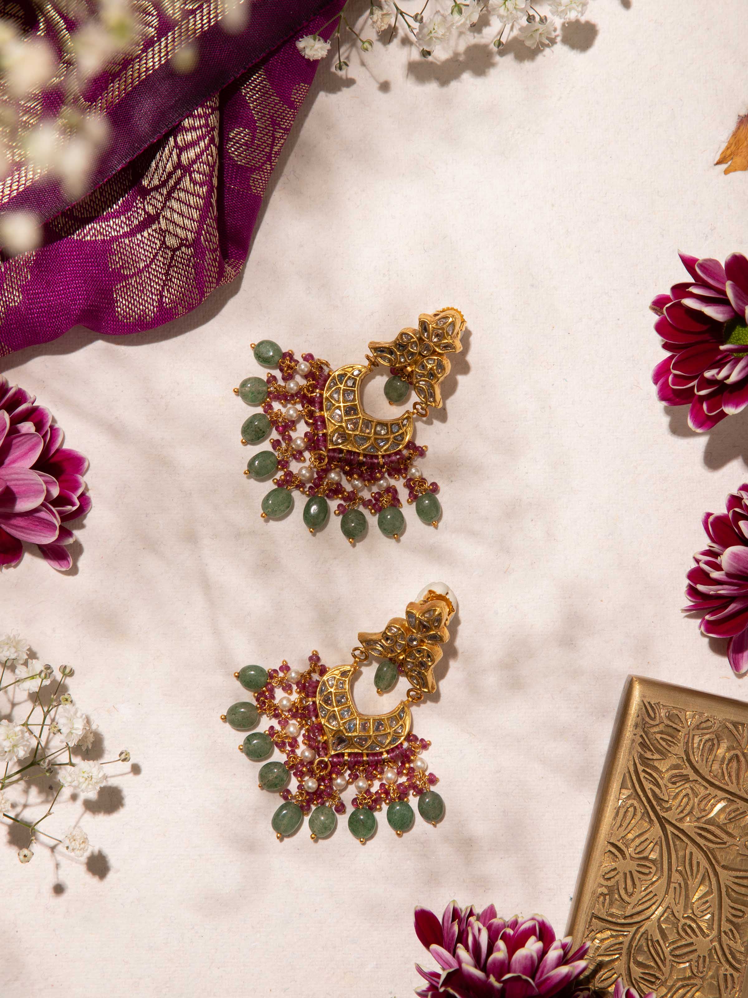 Lifestyle image showing Thappa gold drop earrings worn with traditional attire