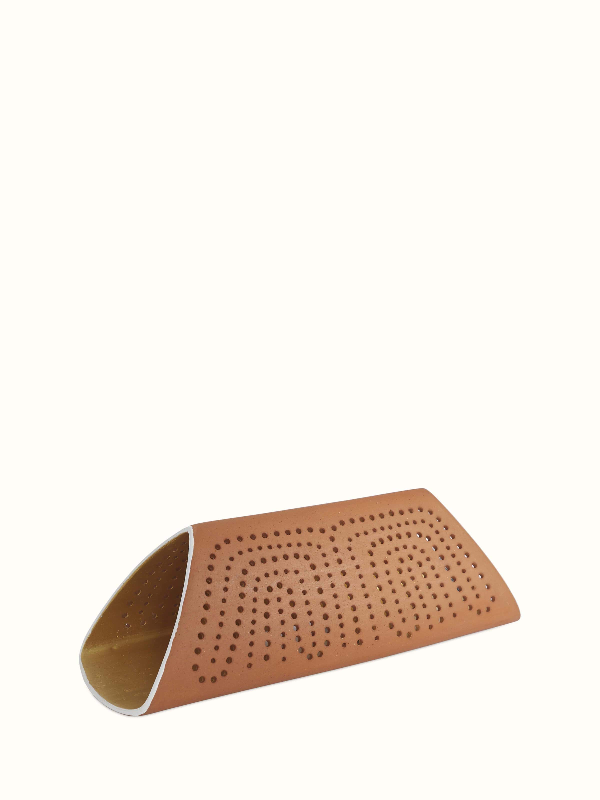 Angled view of terracotta wall light highlighting the detailed design and warm terracotta color