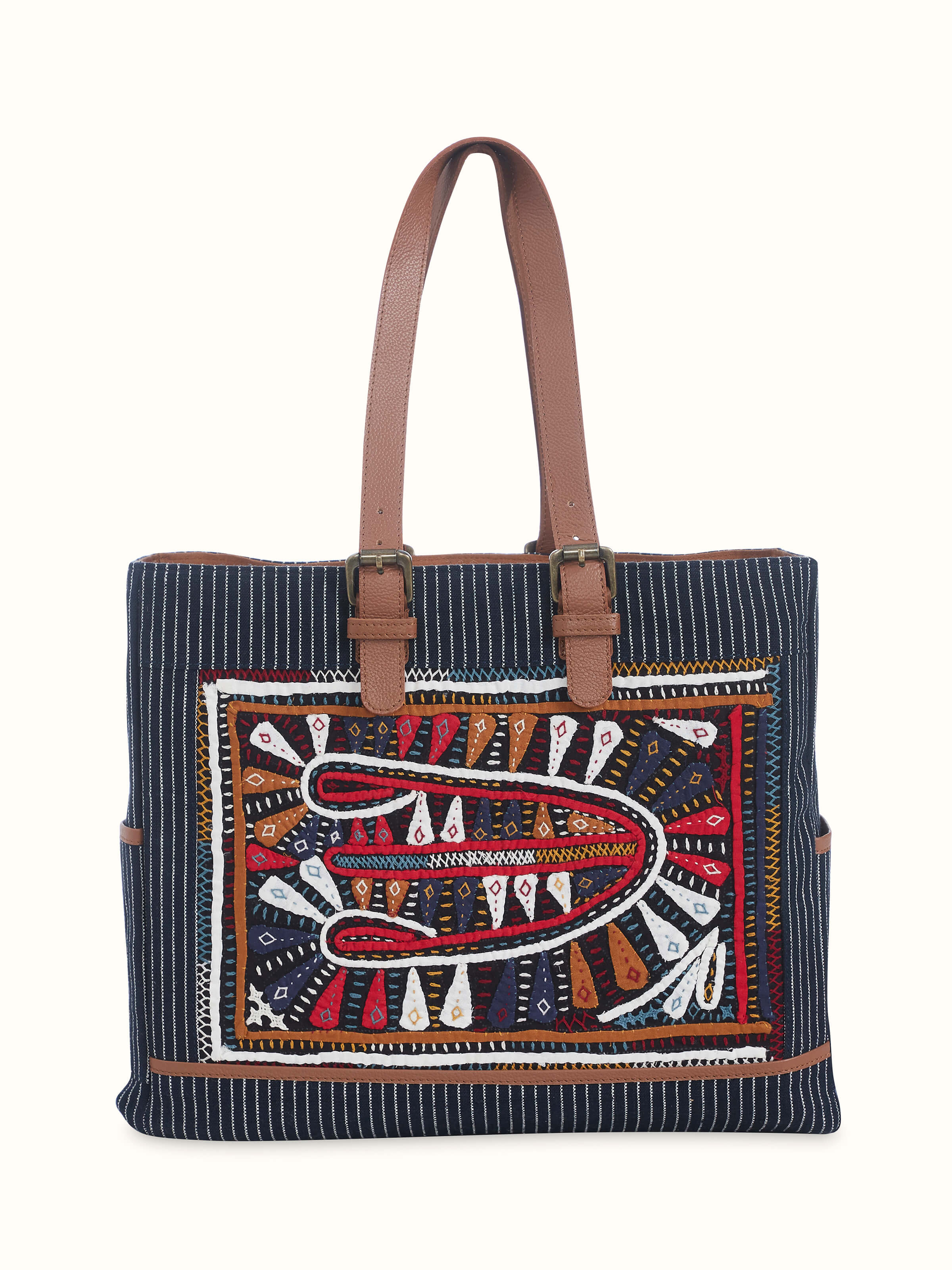 Indigo leather and textile embroidered tote bag with traditional patterns, displayed front-facing.