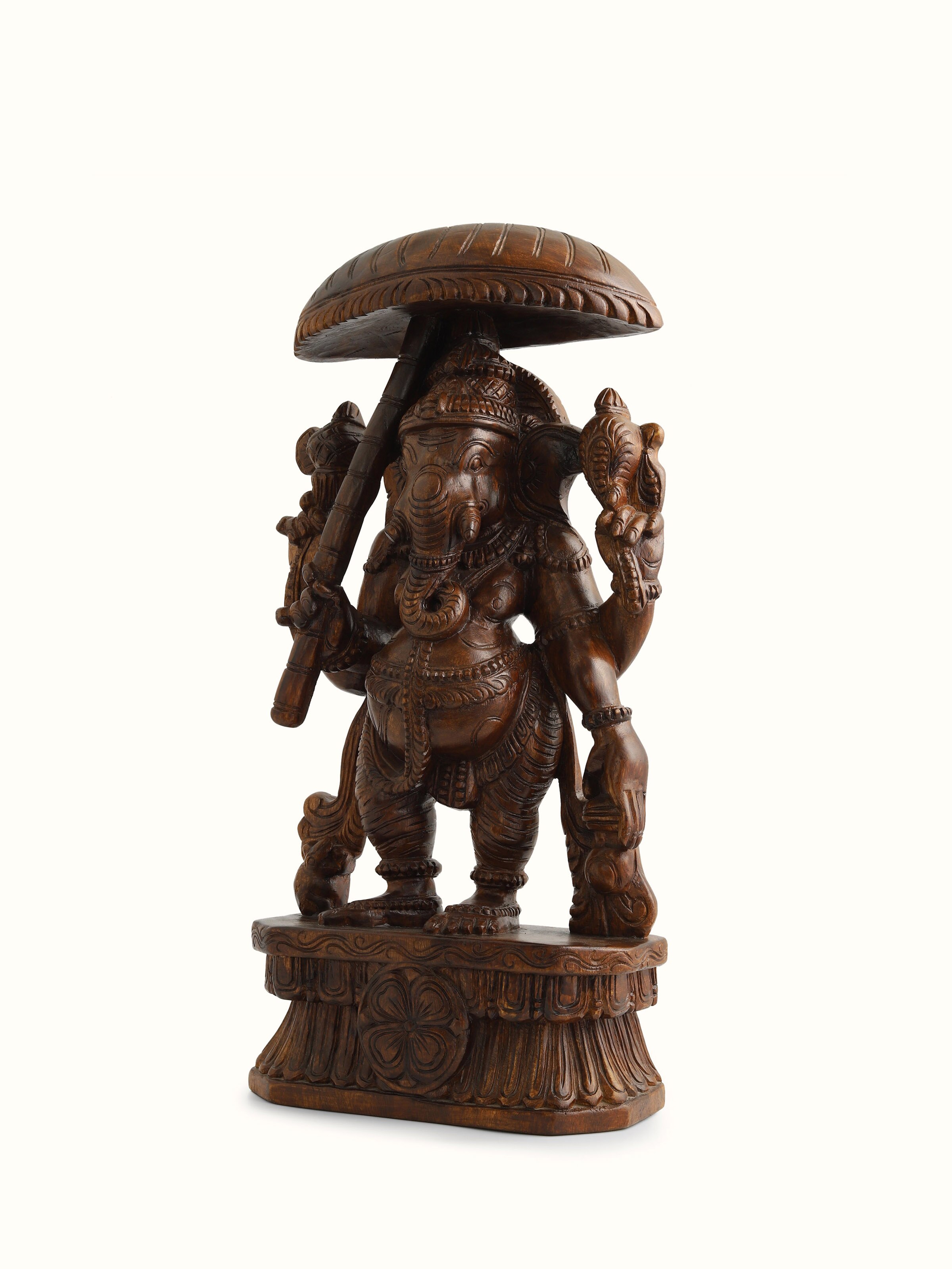 Angled view of Vaagai Wood Ganesha with Umbrella Idol, highlighting the ornate umbrella and elegant form of the deity.