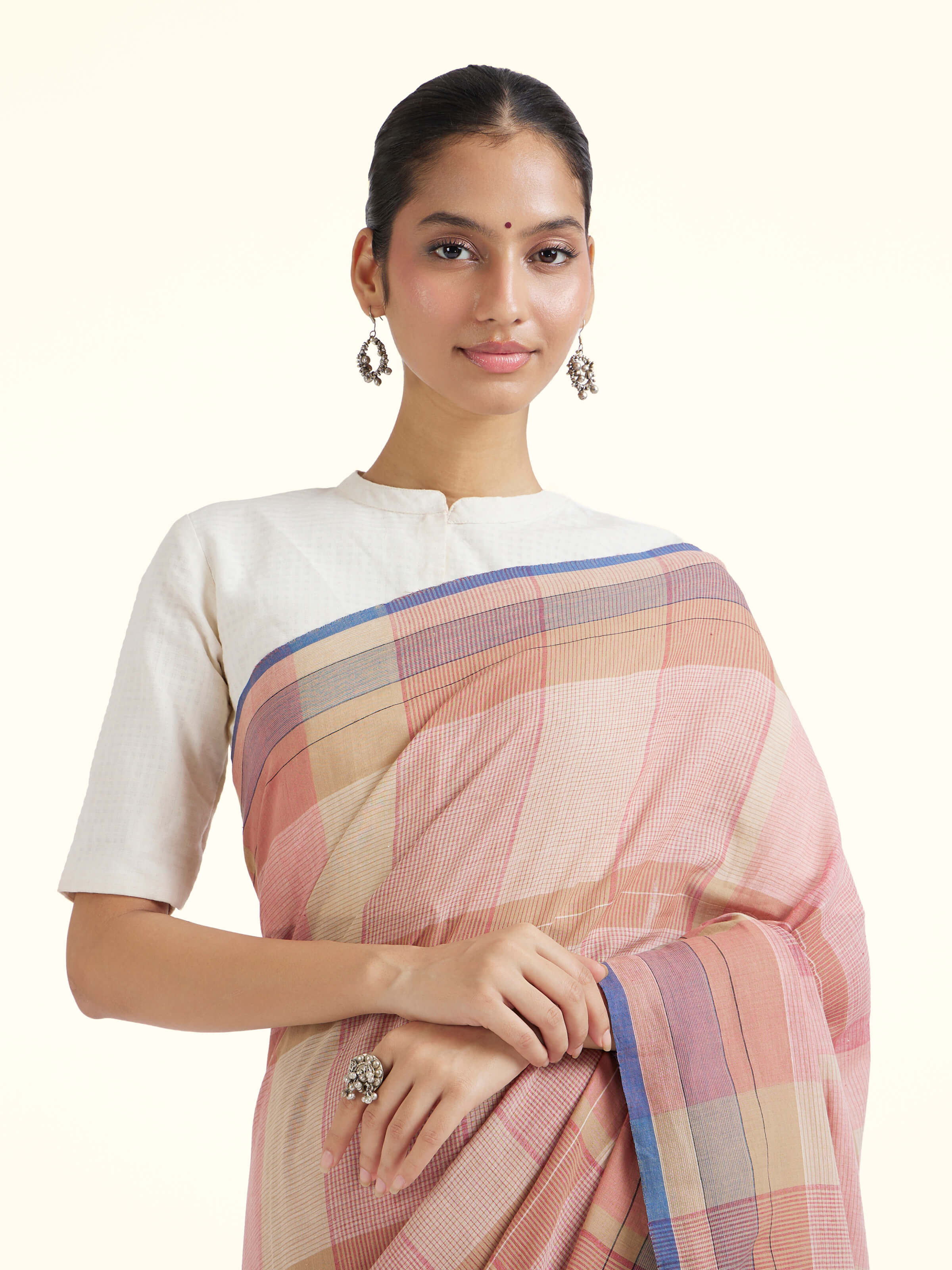 Angled view of brown cotton Bengal Jamdani saree highlighting jamdani weave