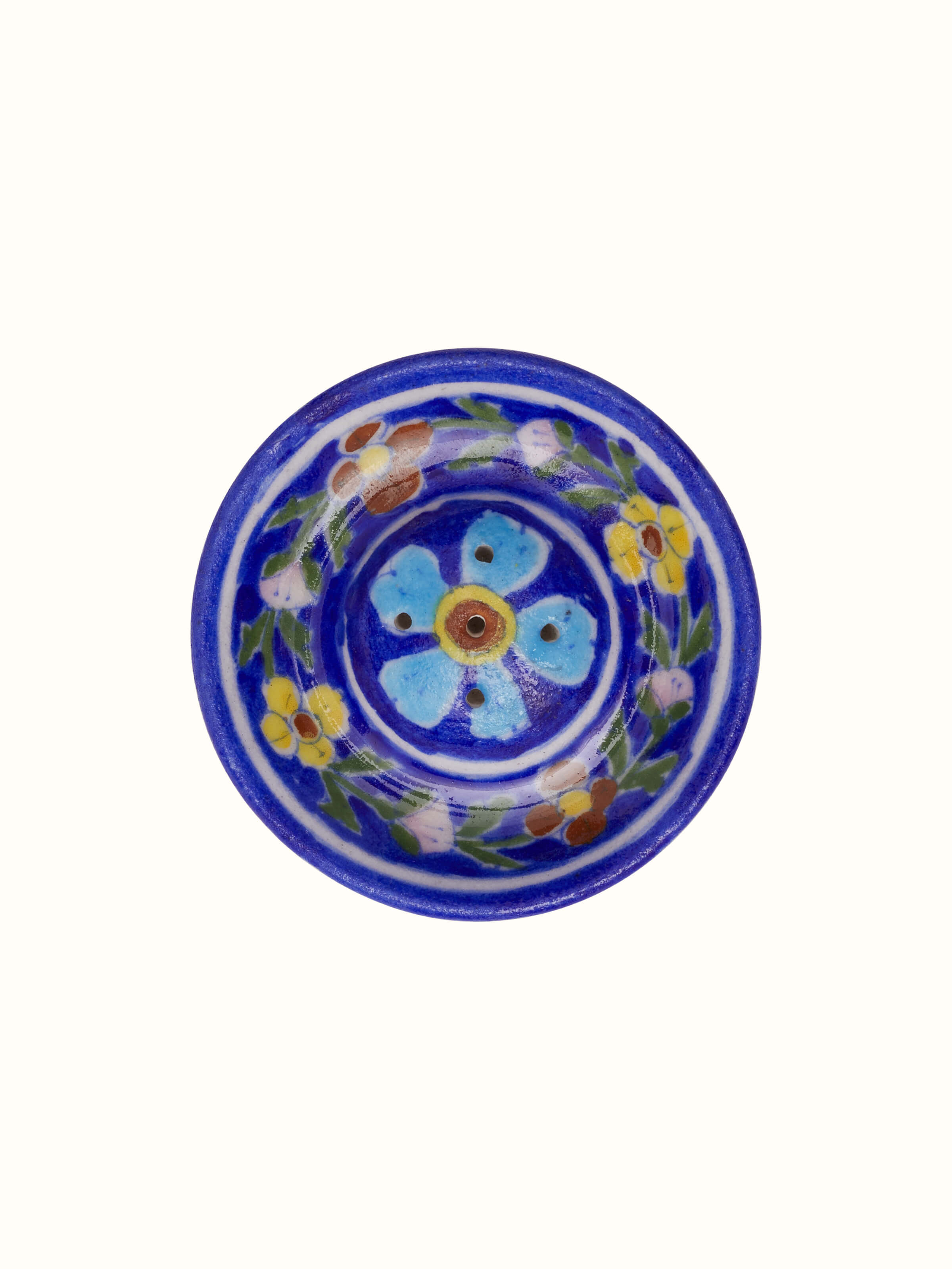 Top angled view of blue pottery ceramic floral incense stick holder