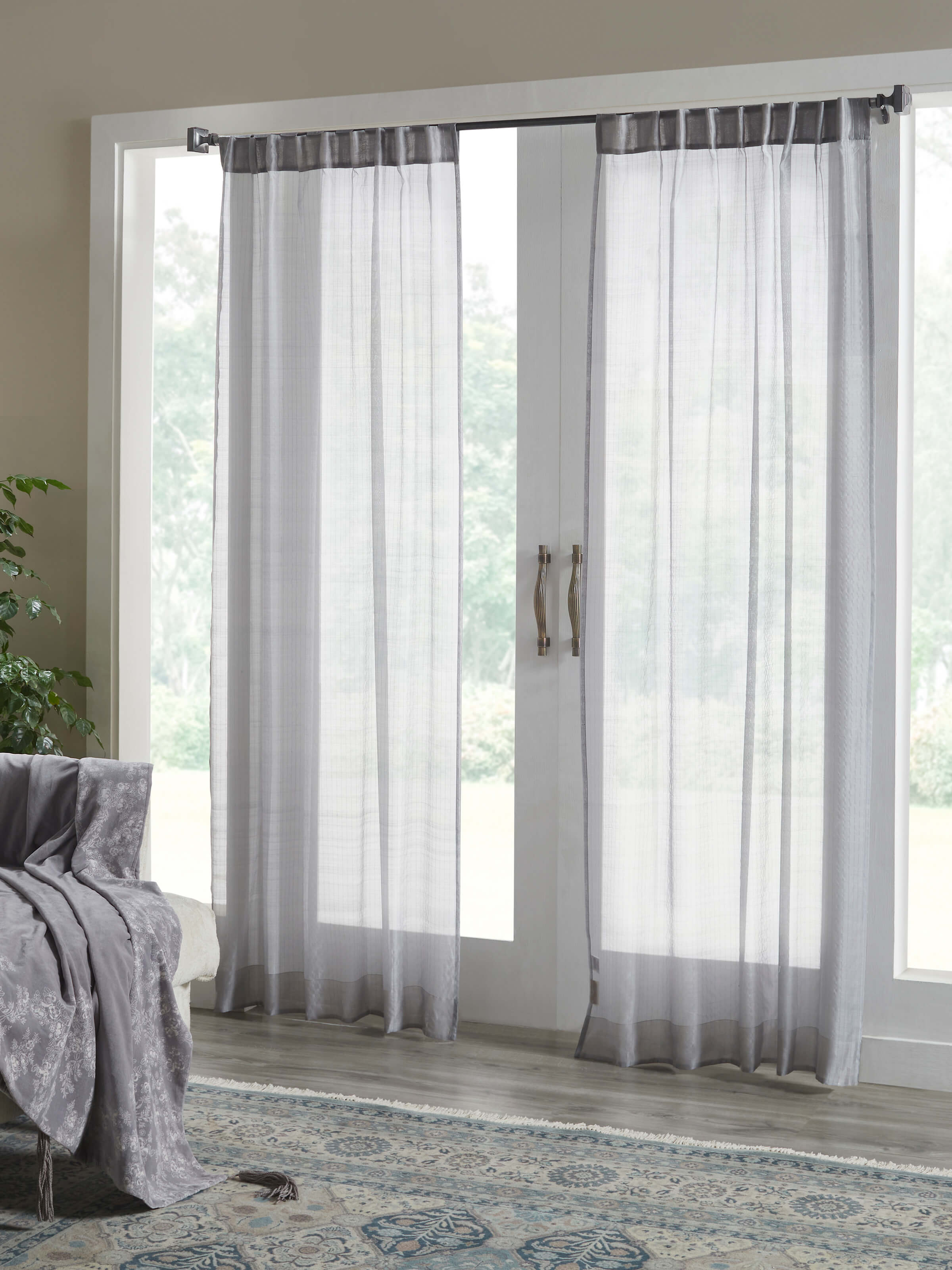 Living room setup showcasing elegant grey Maheshwari handloom curtain.