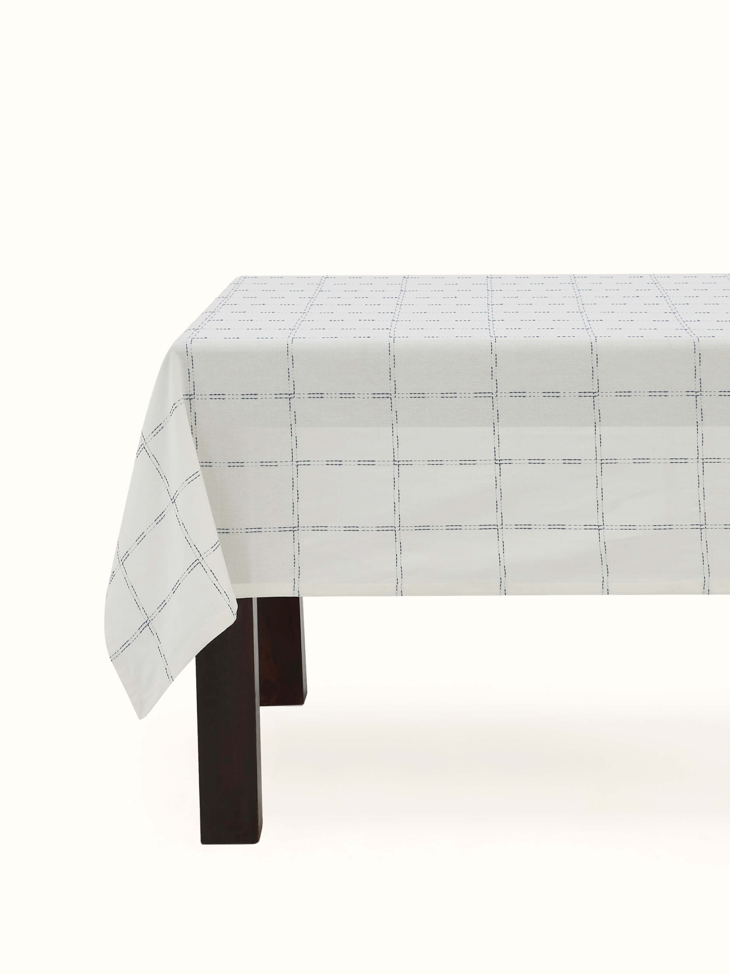 Angled view displaying the indigo checkered pattern spread elegantly over a 6-seater table