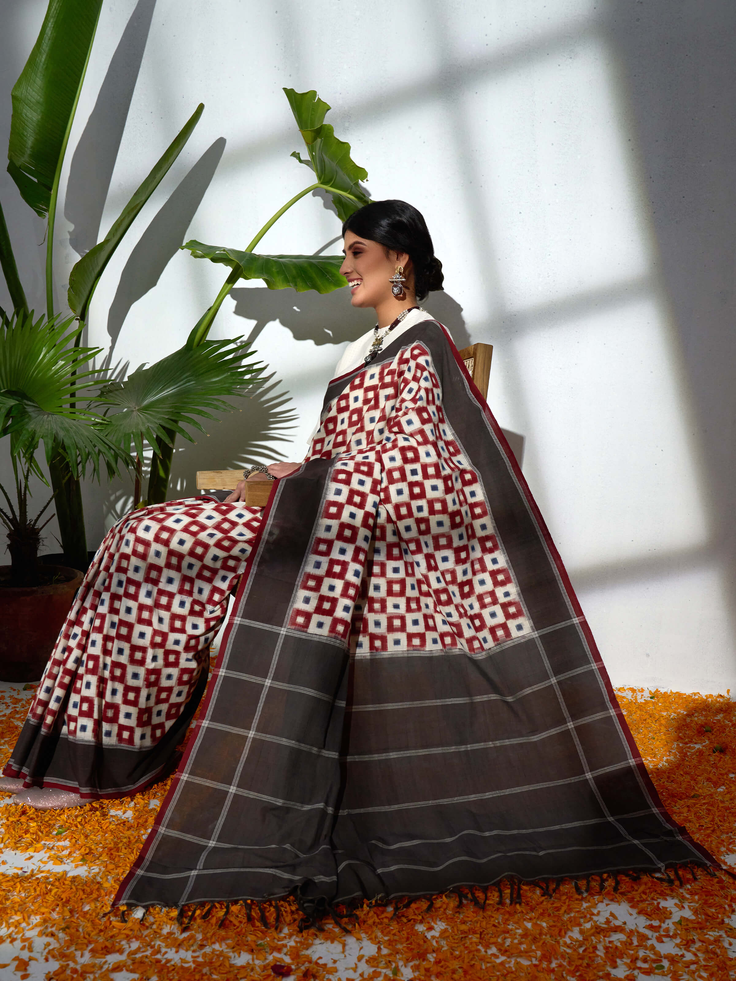Angled view of brown cotton double ikat saree highlighting ikat motifs