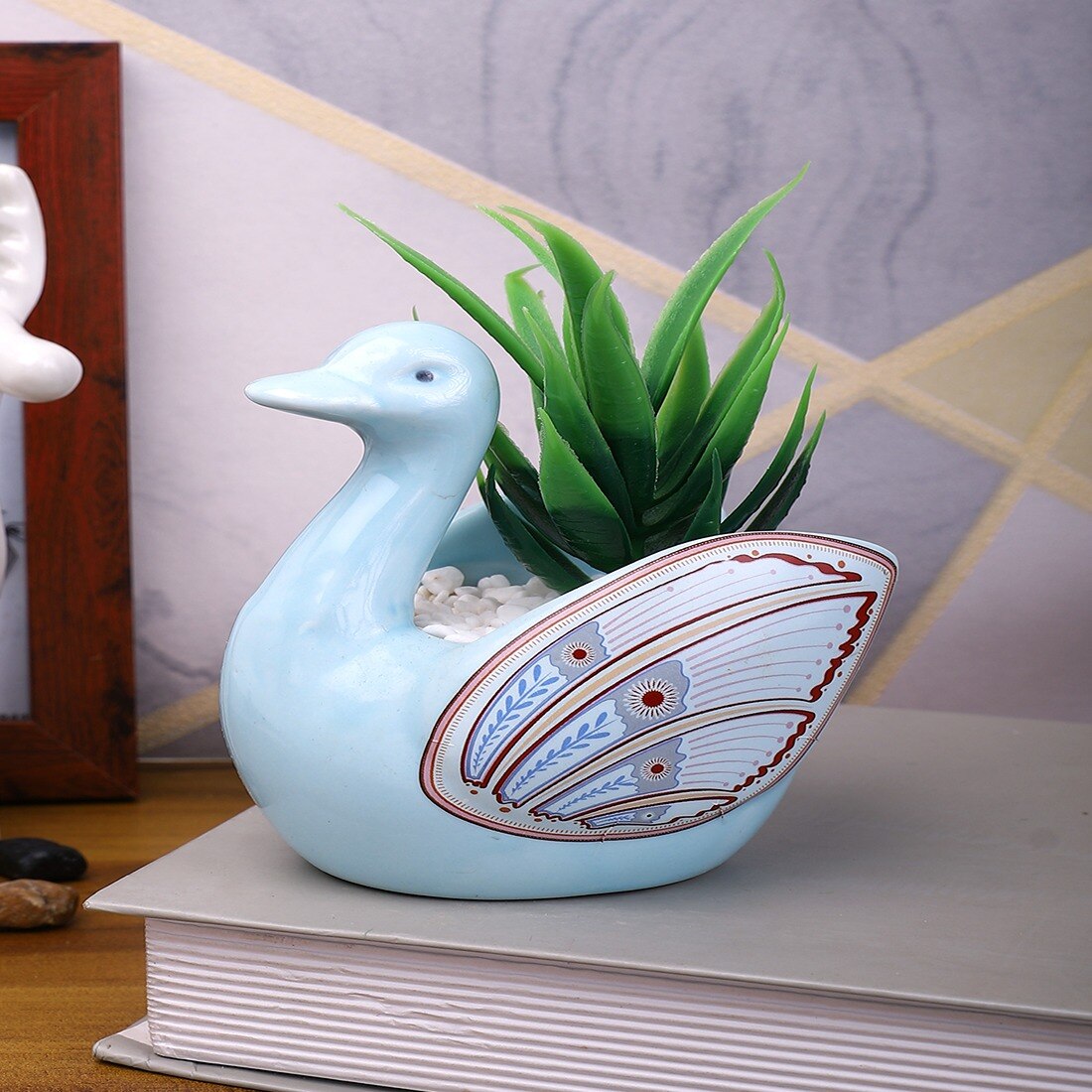 Fern Plant Inside An Artistic Blue Swan Ceramic Pot