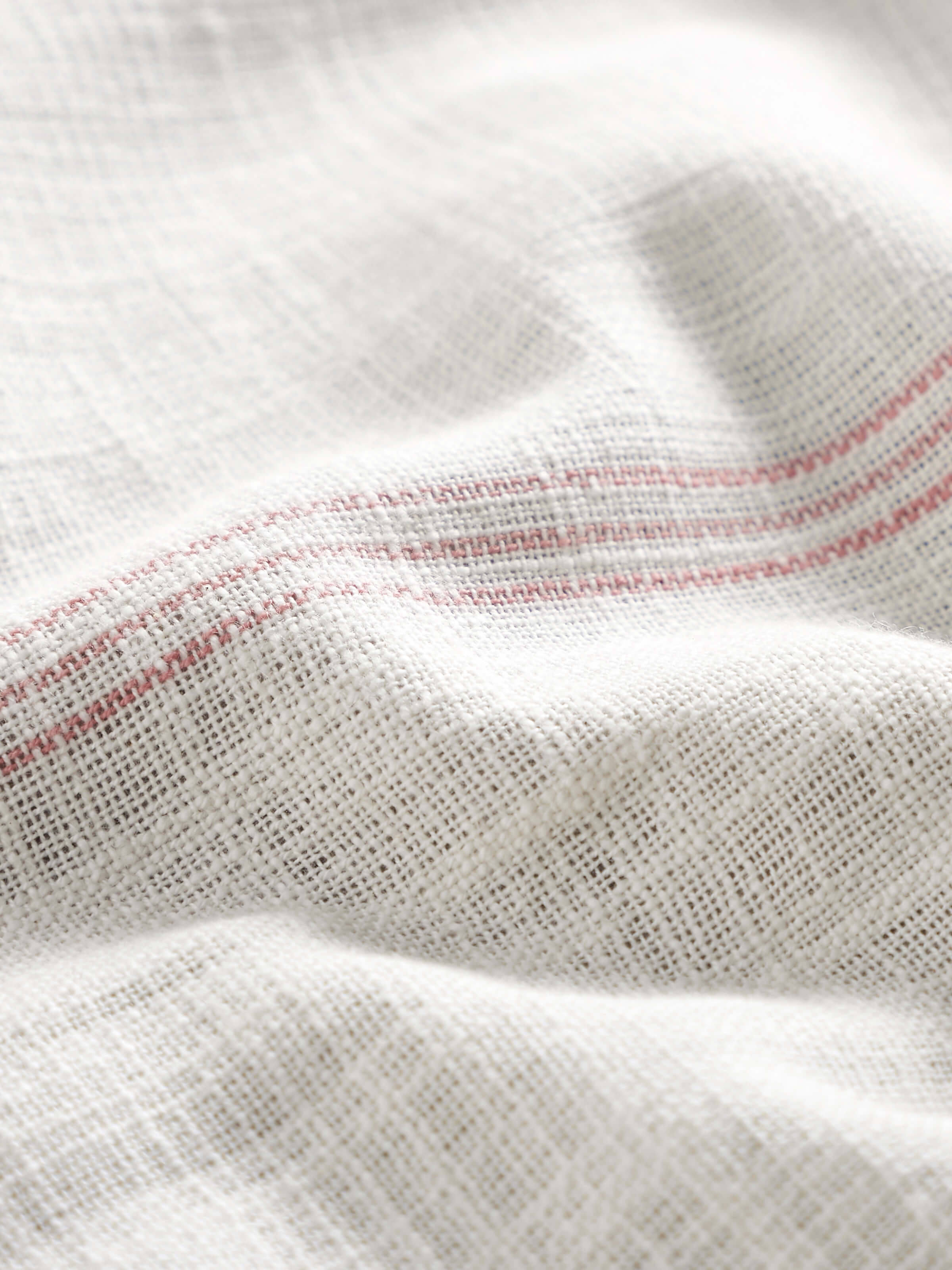 Detail shot focusing on the fabric weave and handloom texture