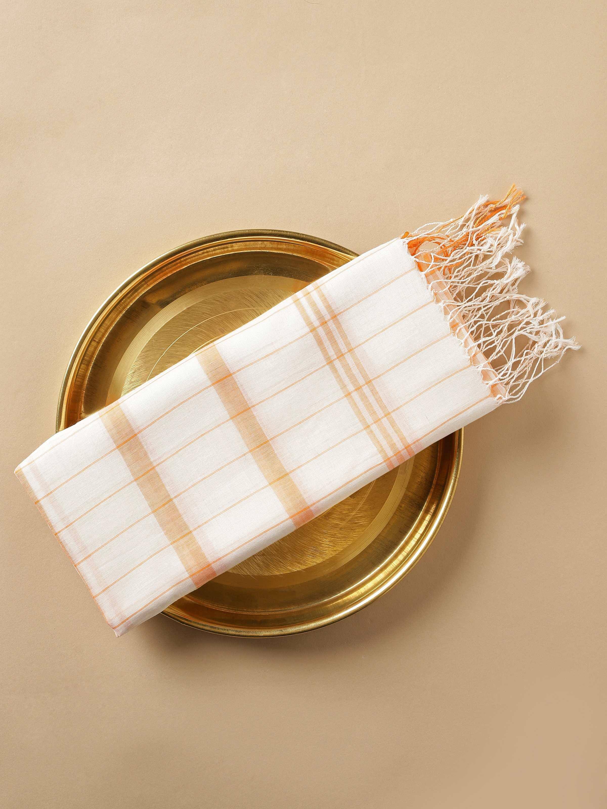 Top view of orange cotton stole rolled up, emphasizing fabric softness and weave details.