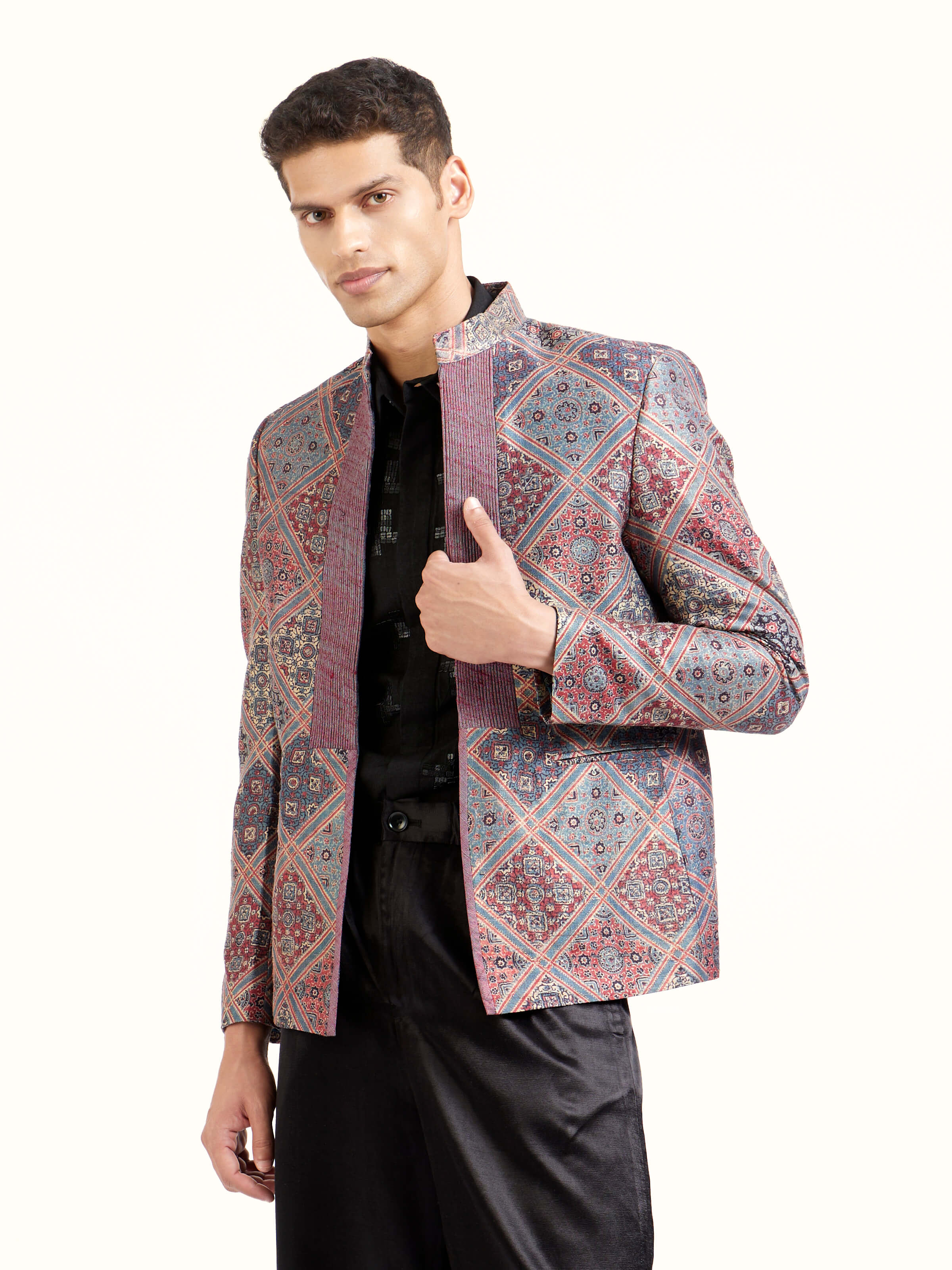 Angled view of indigo silk ajrakh block printed jacket highlighting block print patterns
