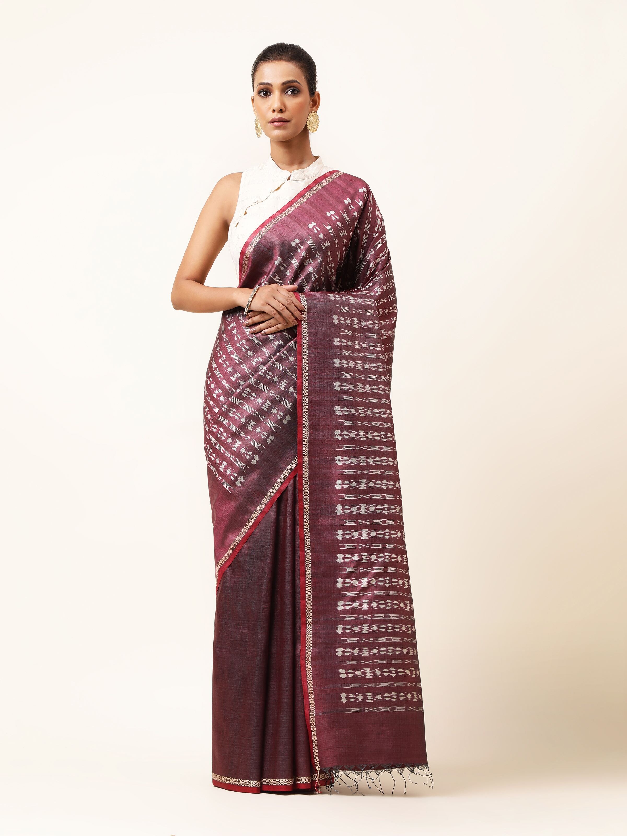 Front view of purple tussar silk Odisha Ikat saree showcasing vibrant geometric Ikat patterns.