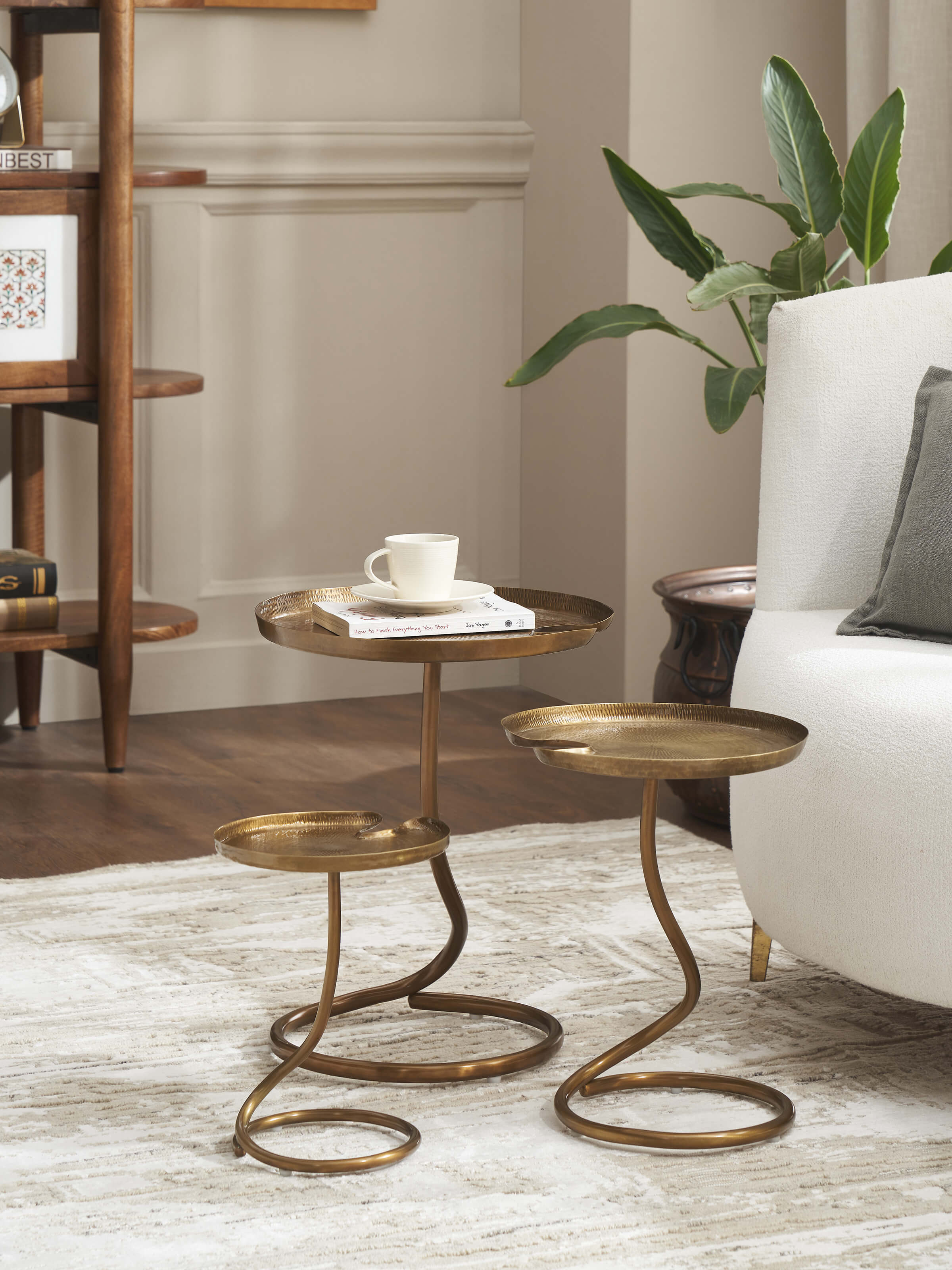 Lifestyle view of Antique Brass Thathera Nesting Table