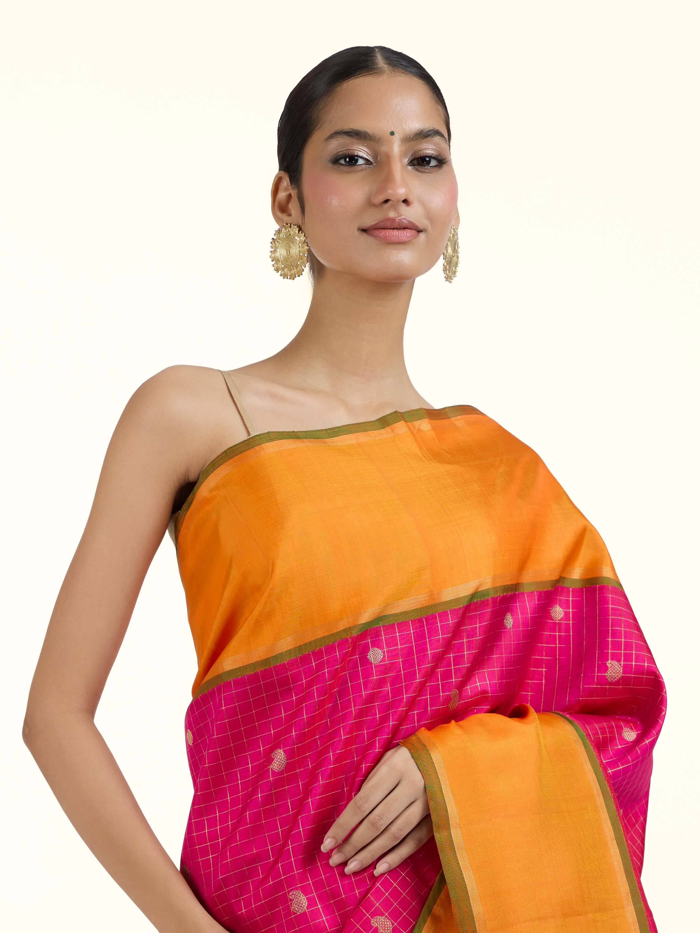 Angled view of pink silk Kancheepuram saree highlighting traditional weave and sheen