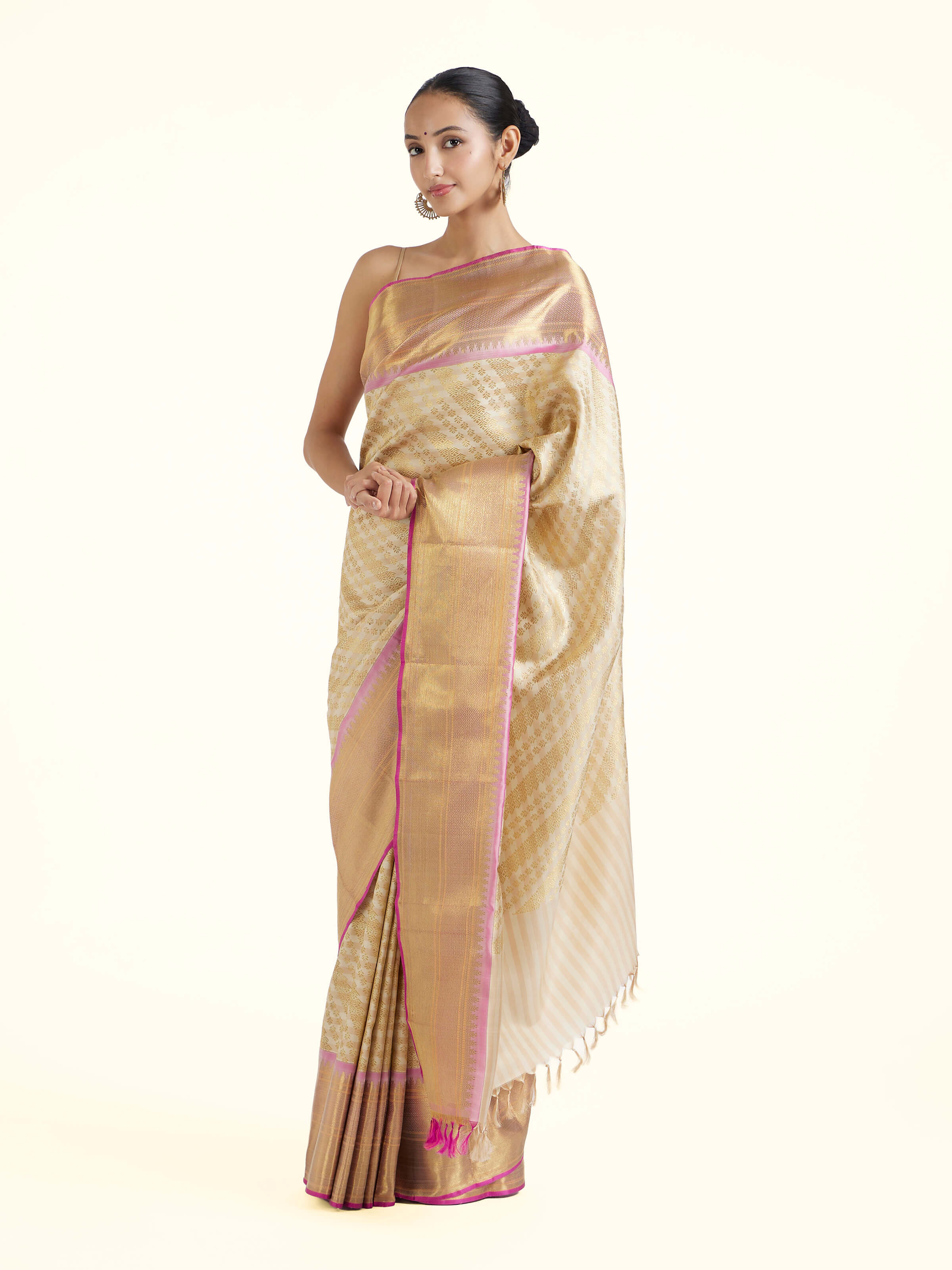 Side view of off-white silk Kancheepuram saree with graceful drape and broad border