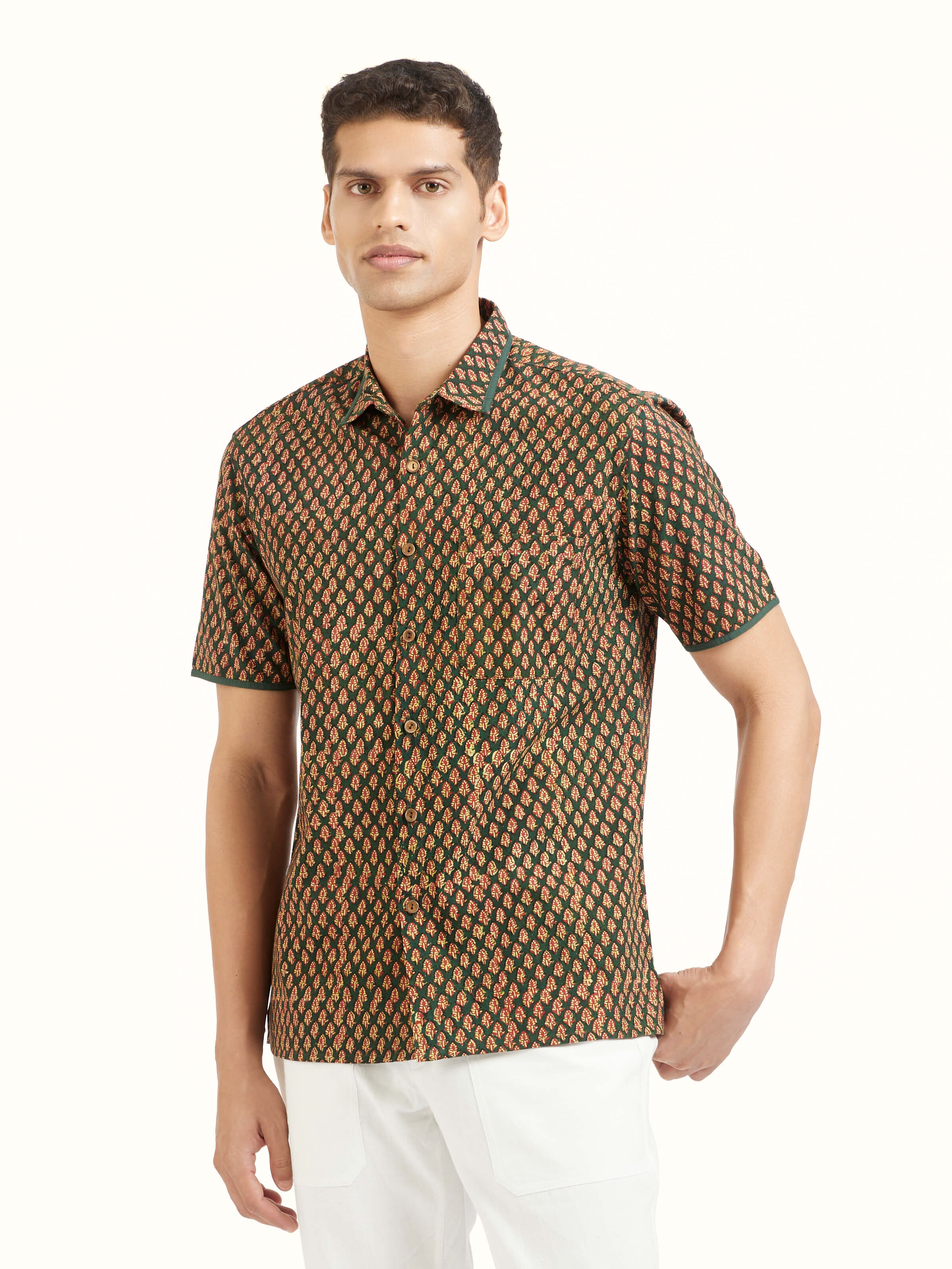 Angled view of teal fadad hand block print pure cotton shirt emphasizing artisanal patterns