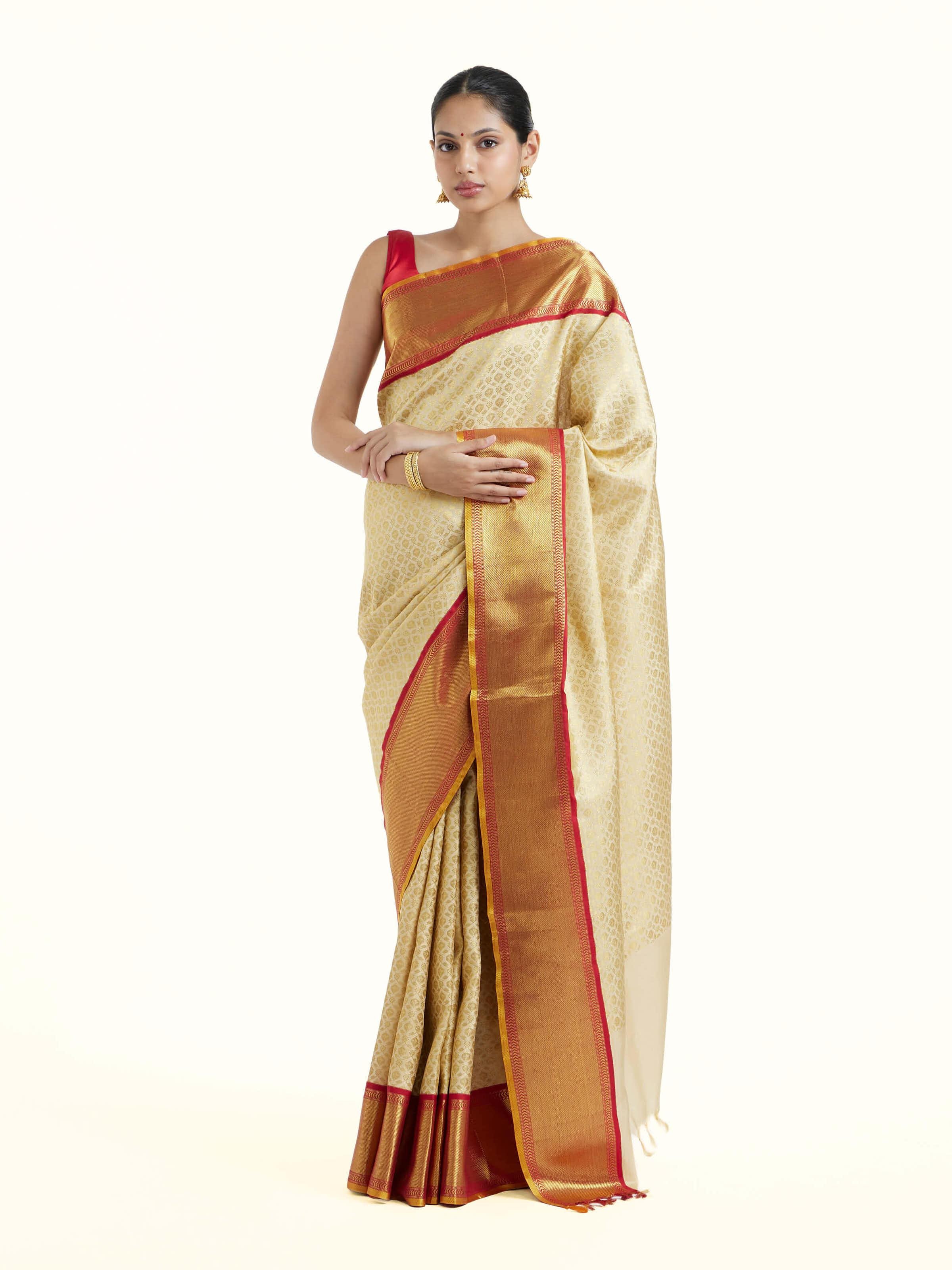 Side view of peach silk Kancheepuram saree highlighting drape and pleat details