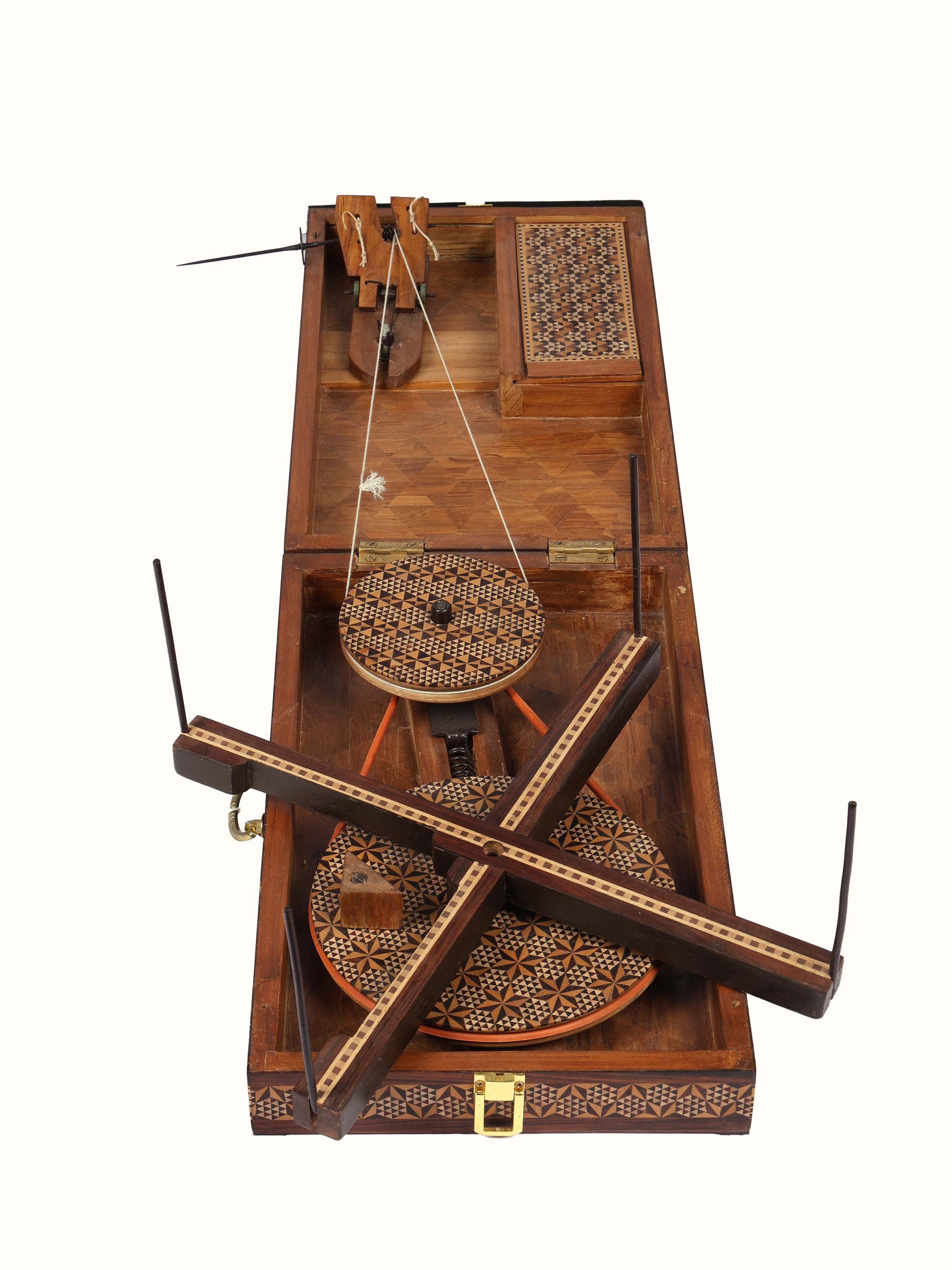 Close-up detail of marquetry rosewood charkha showing inlay craftsmanship