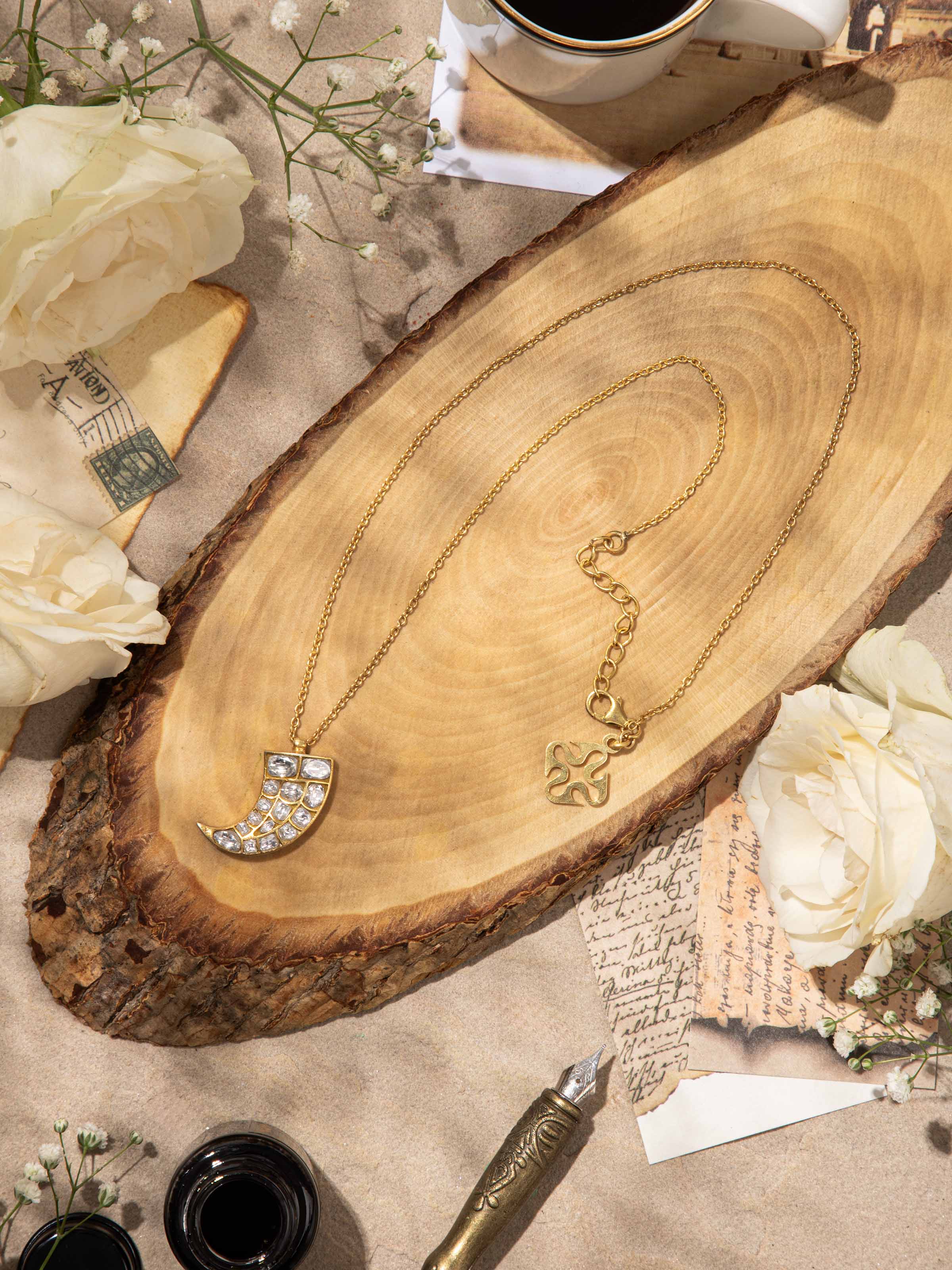 Lifestyle shot showcasing the pendant and chain styled on the neckline for an elegant look