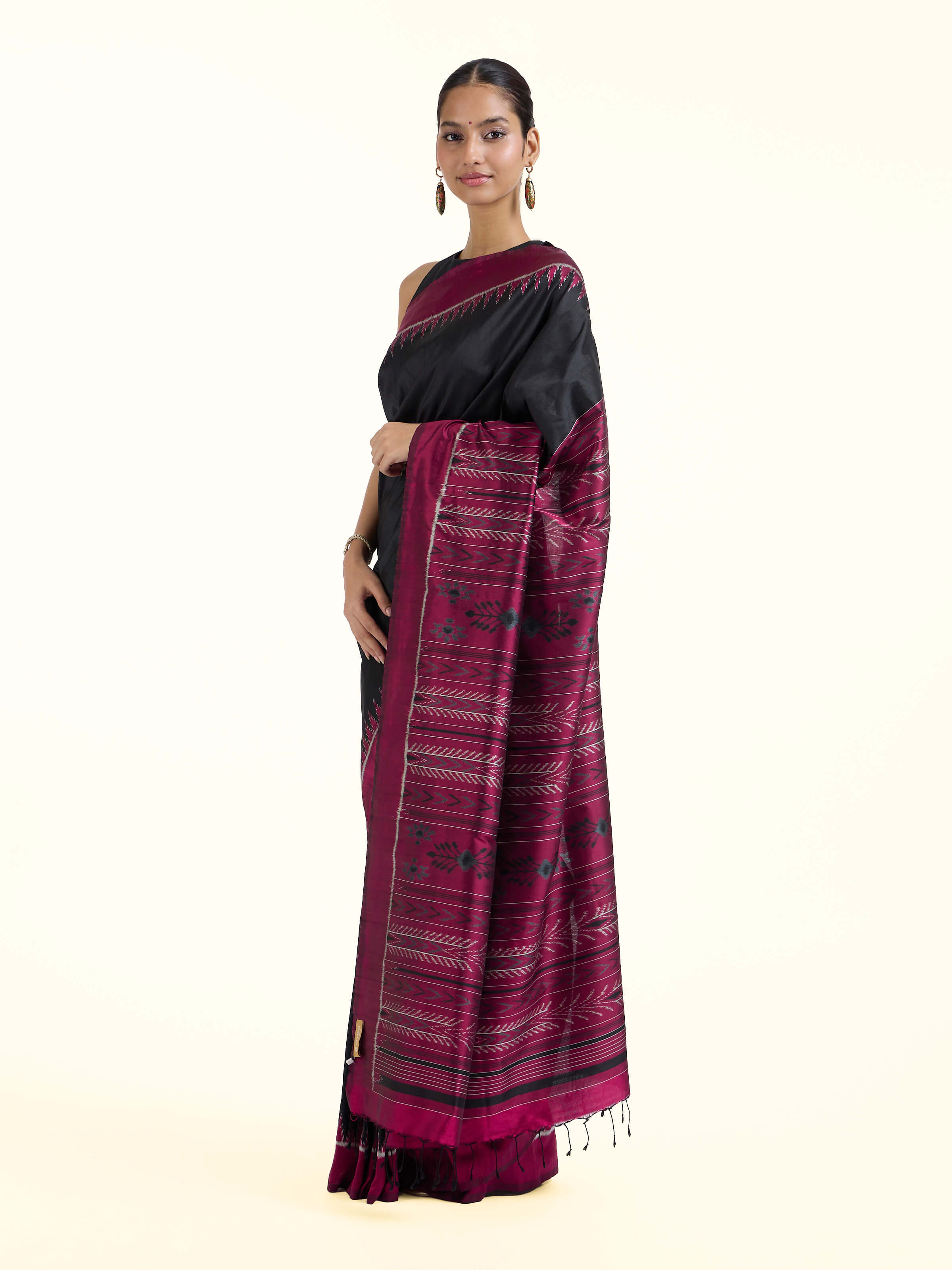 Side view of black mulberry silk Odisha ikat bandha saree highlighting rich drape