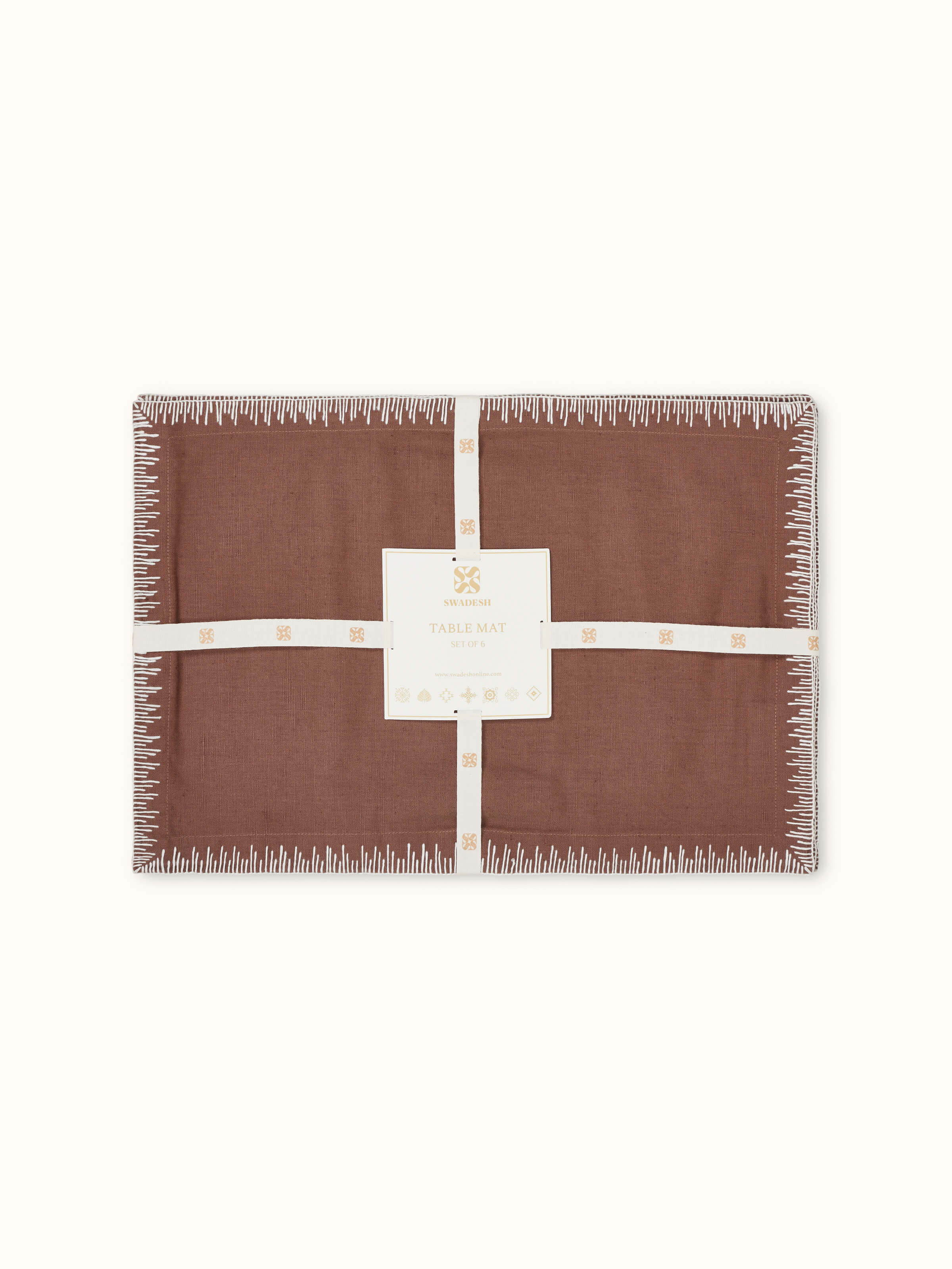 Corner and stitch detail of brown linen cotton embroidered table mat