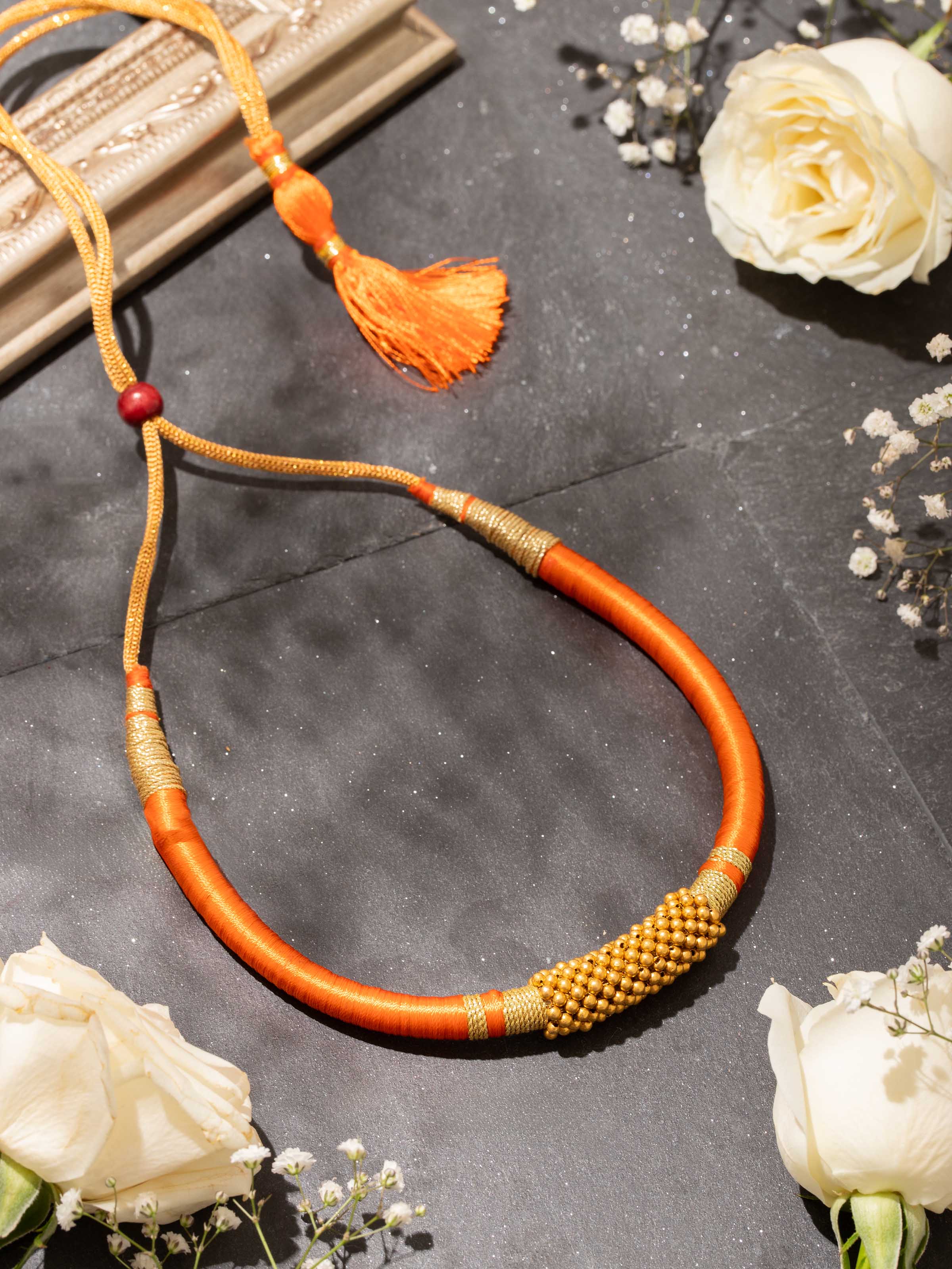 Close-up detail of Thushi gold collar necklace