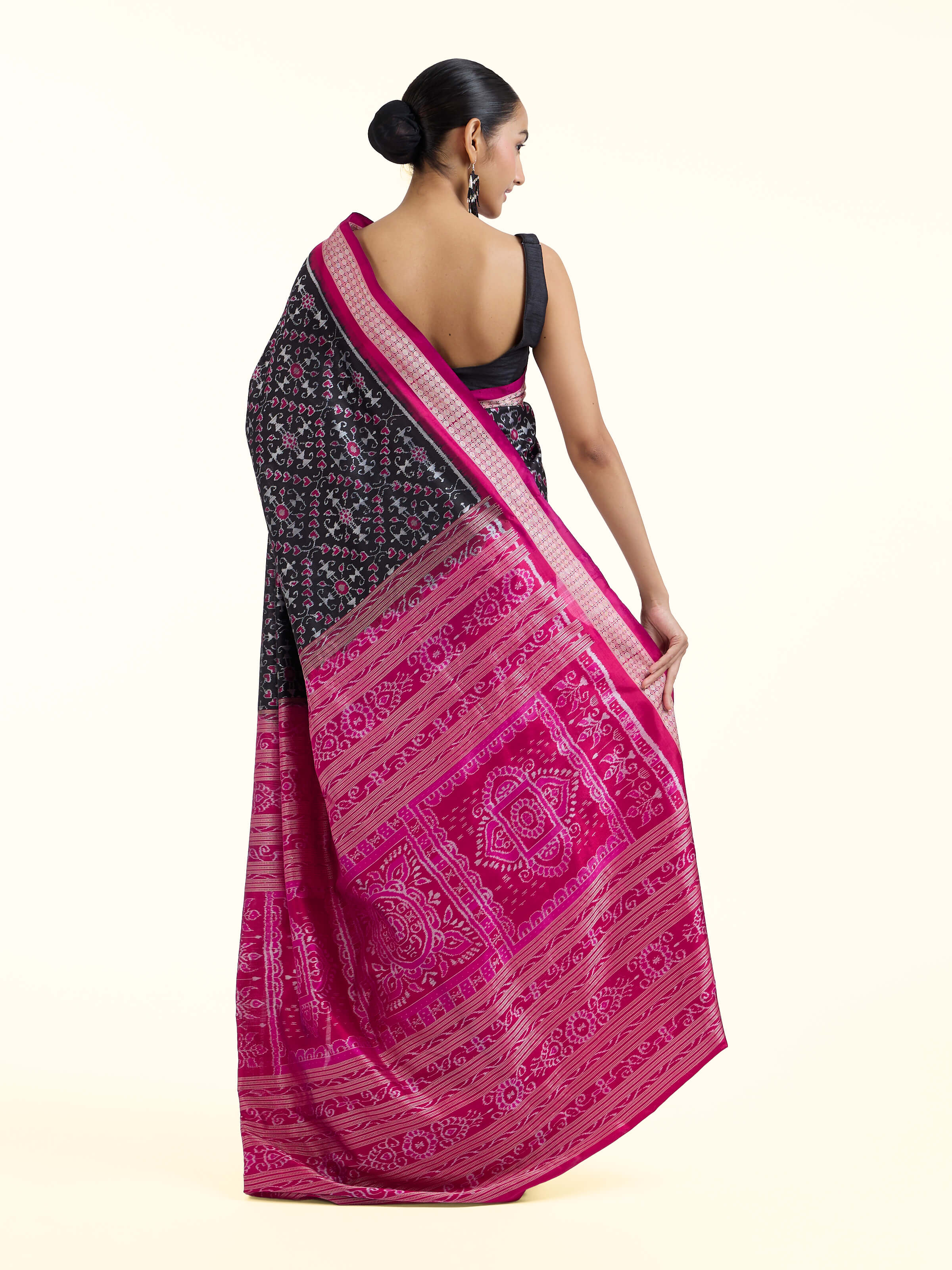 Back view of black mulberry silk Bandha Odisha Ikat saree displaying full design