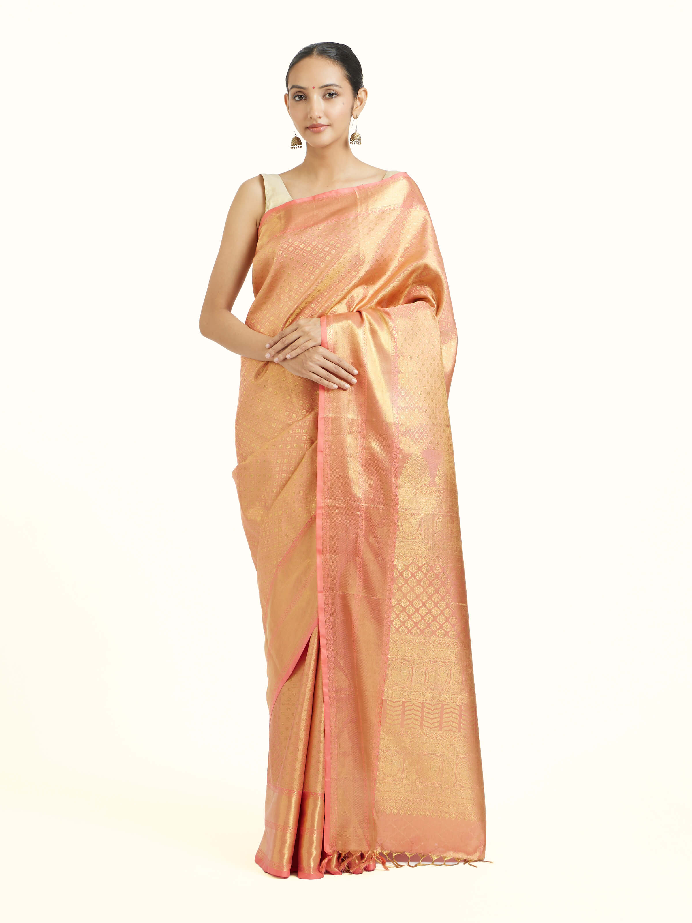 Front view of peach silk Kancheepuram saree with rich zari border