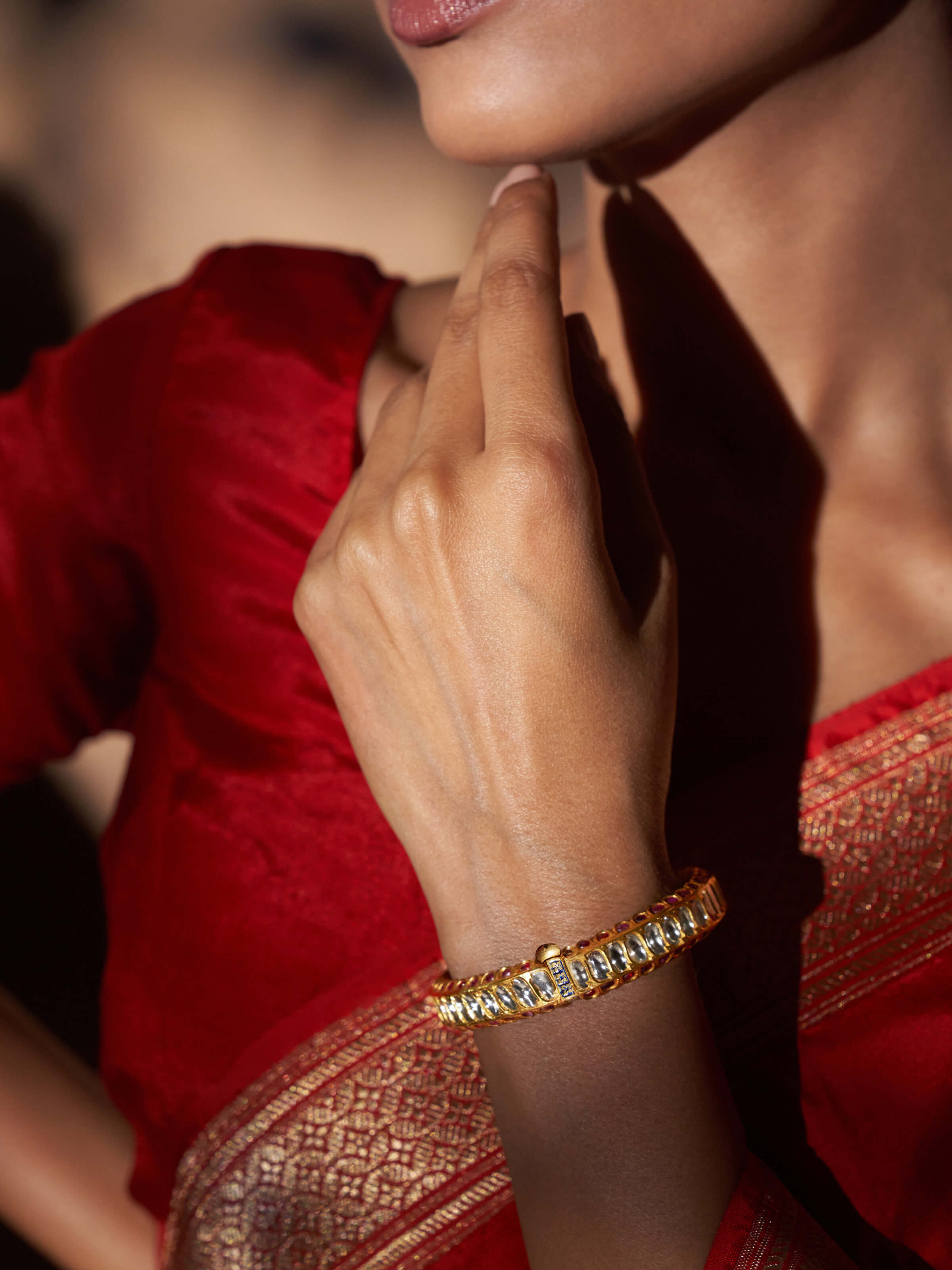 Side view of silversmithing long necklace showcasing its intricate design.