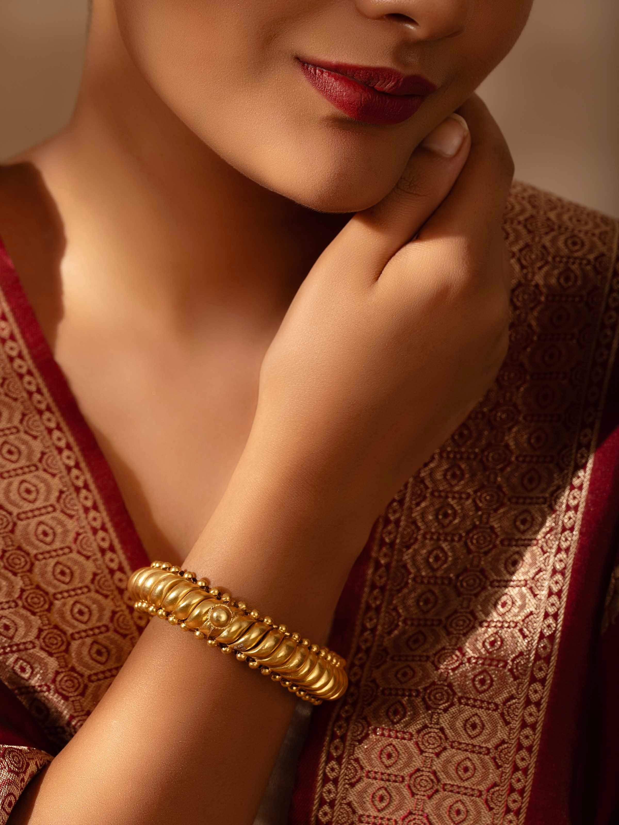 Side view of Smithing Bangle highlighting the detailed craftsmanship and unique design