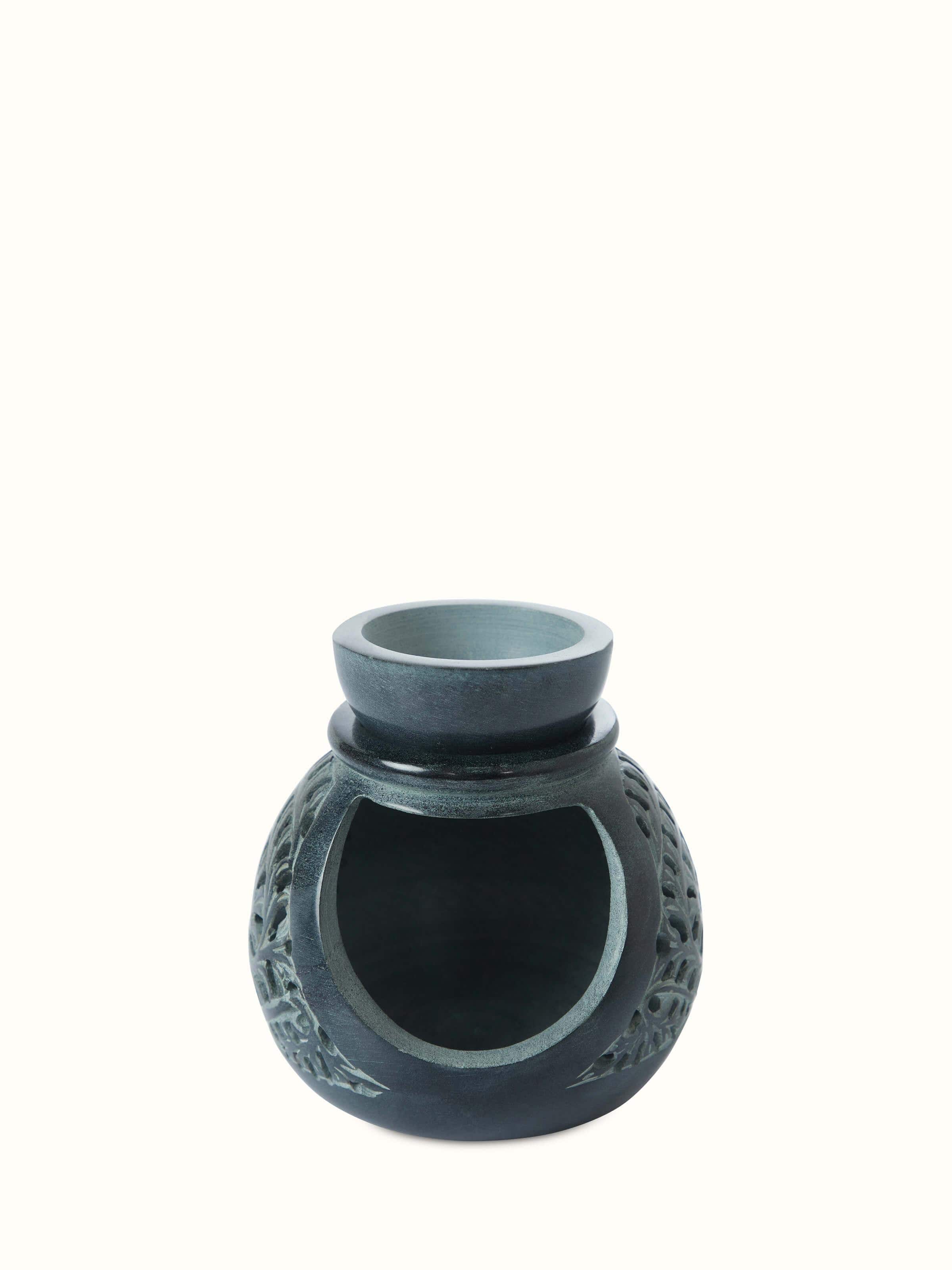 Front view of Carved soapstone aroma oil burner highlighting its detailed carvings and elegant design