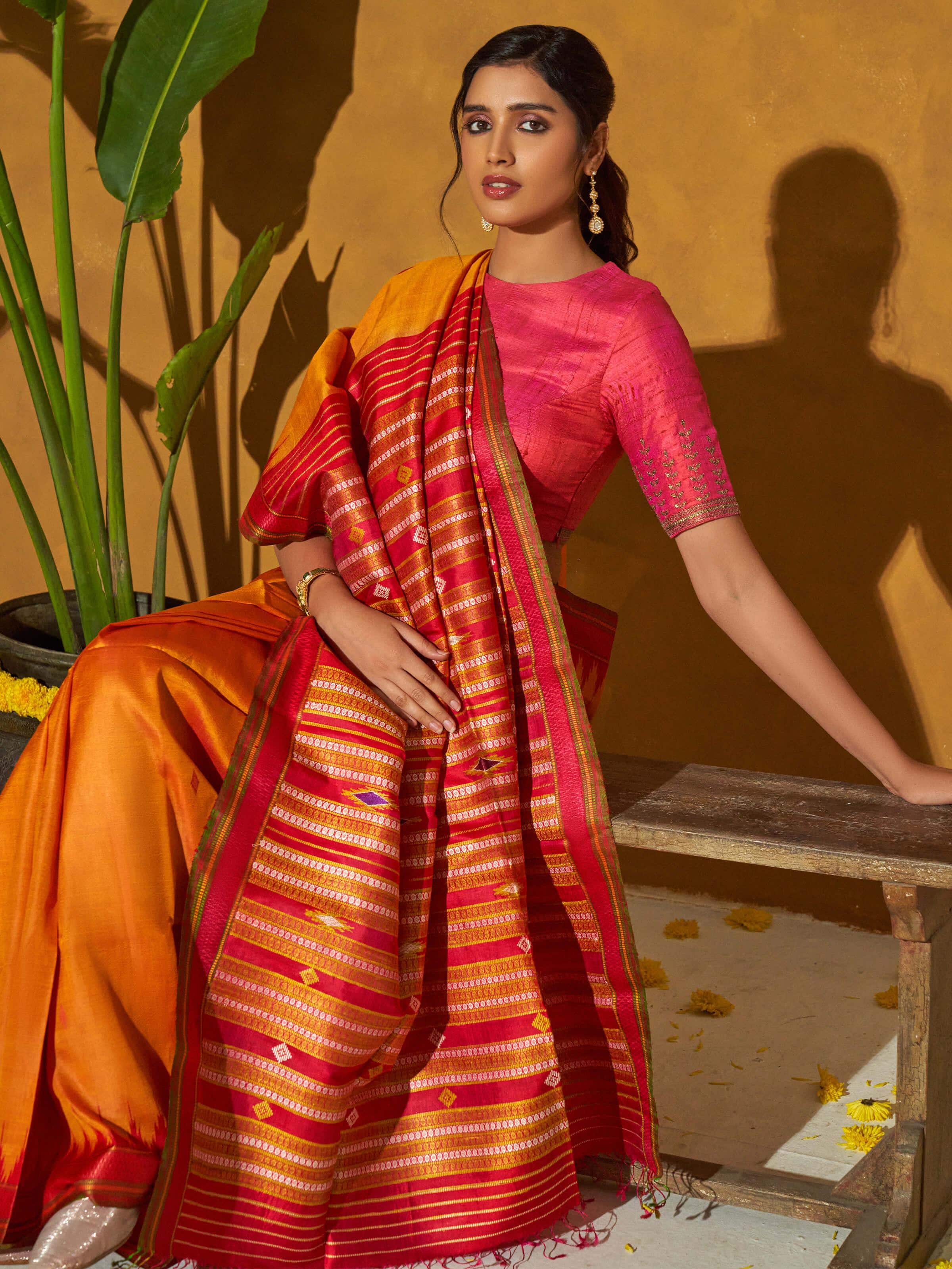 Close-up of orange tussar silk bandha Odisha ikat saree focusing on intricate ikat design