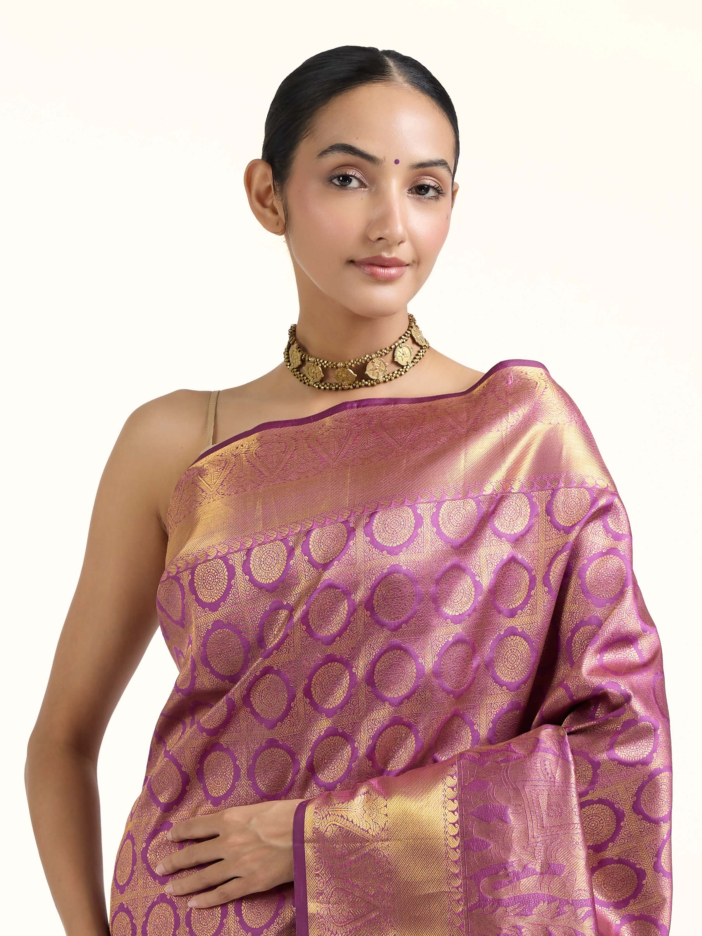 Angled view of purple silk Kancheepuram saree highlighting woven motifs