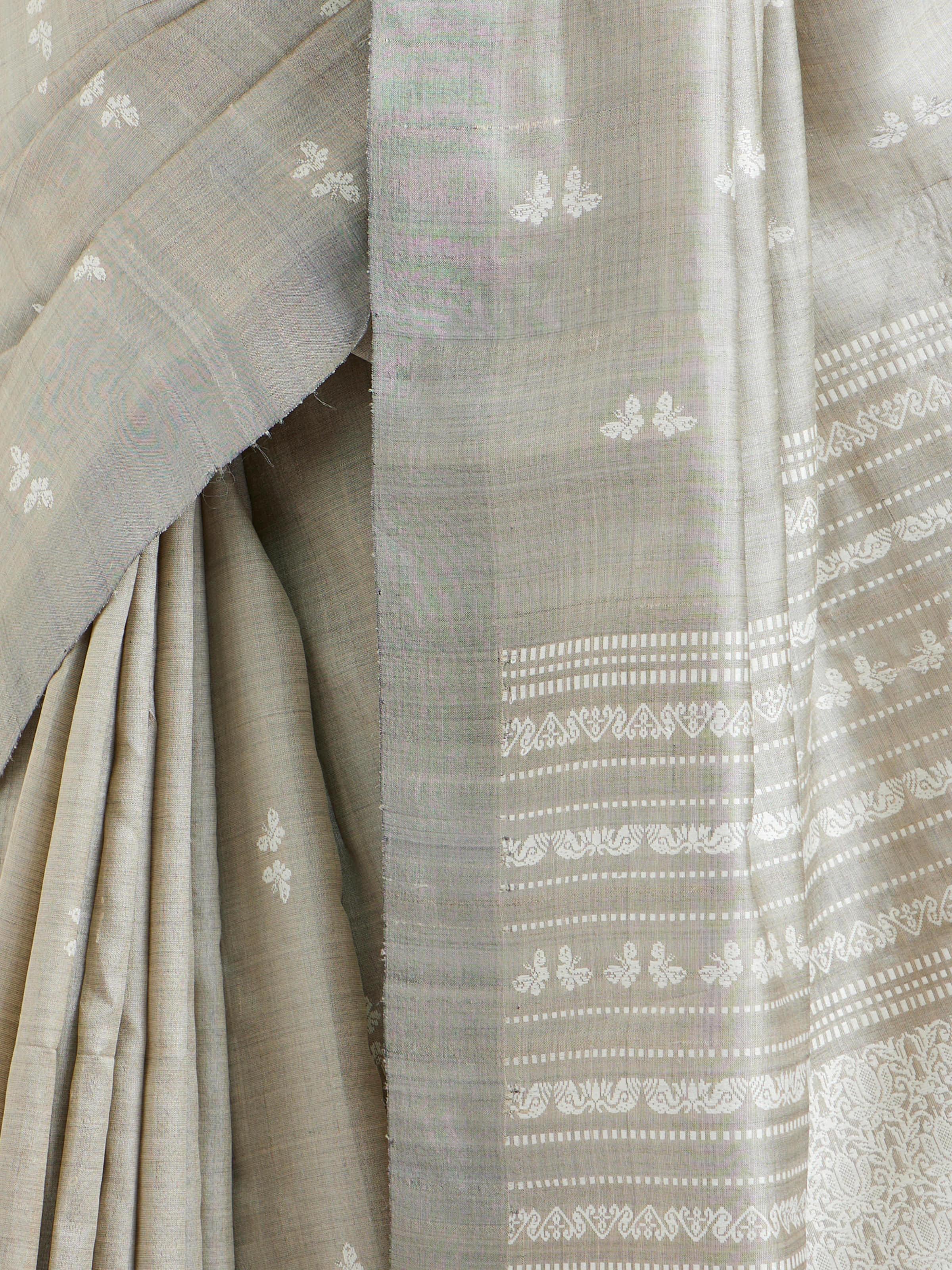 Detail view of grey tussar silk Odisha ikat saree showing intricate ikat craftsmanship