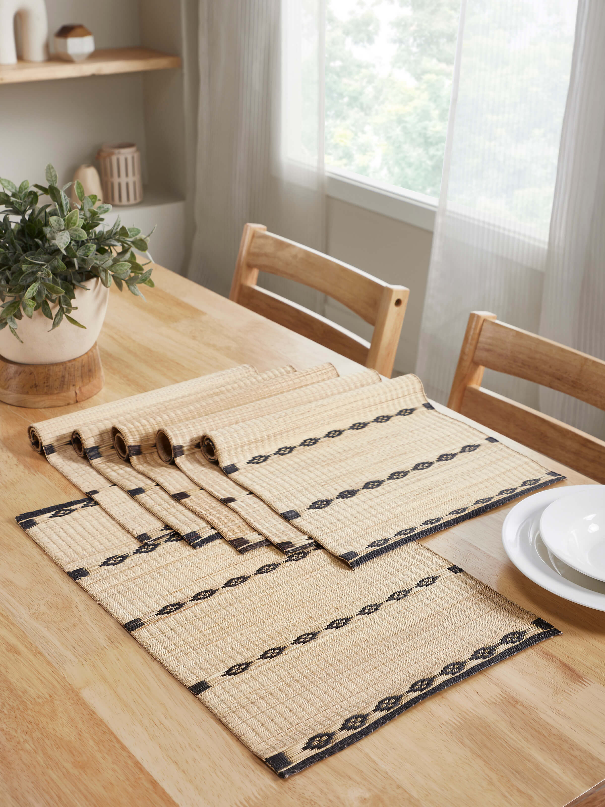 Prakriti Madurkathi black stripe table mats arranged in a rustic dining table setting