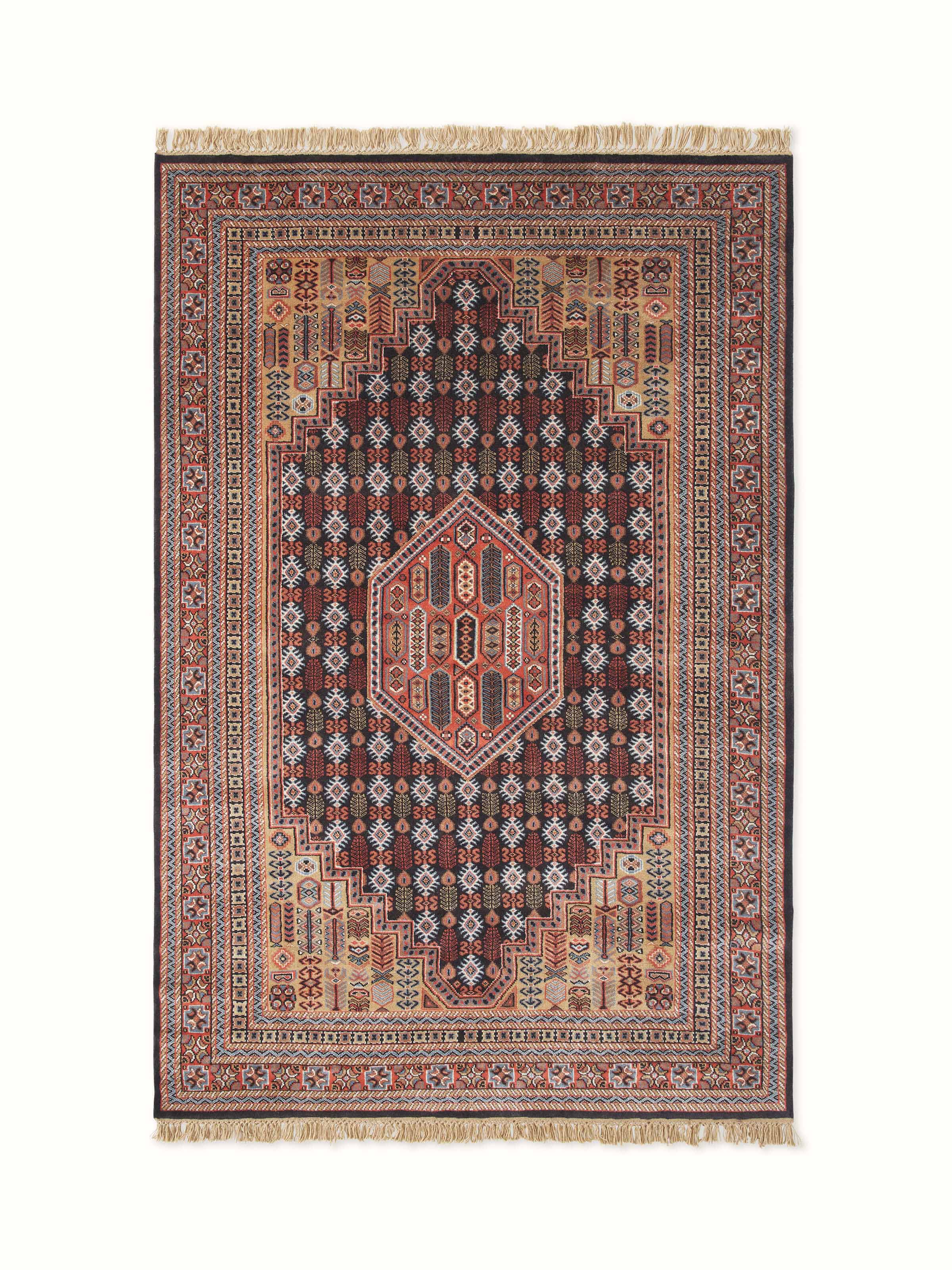 Angled close-up highlighting the intricate black and mustard floral motifs on hand-knotted wool