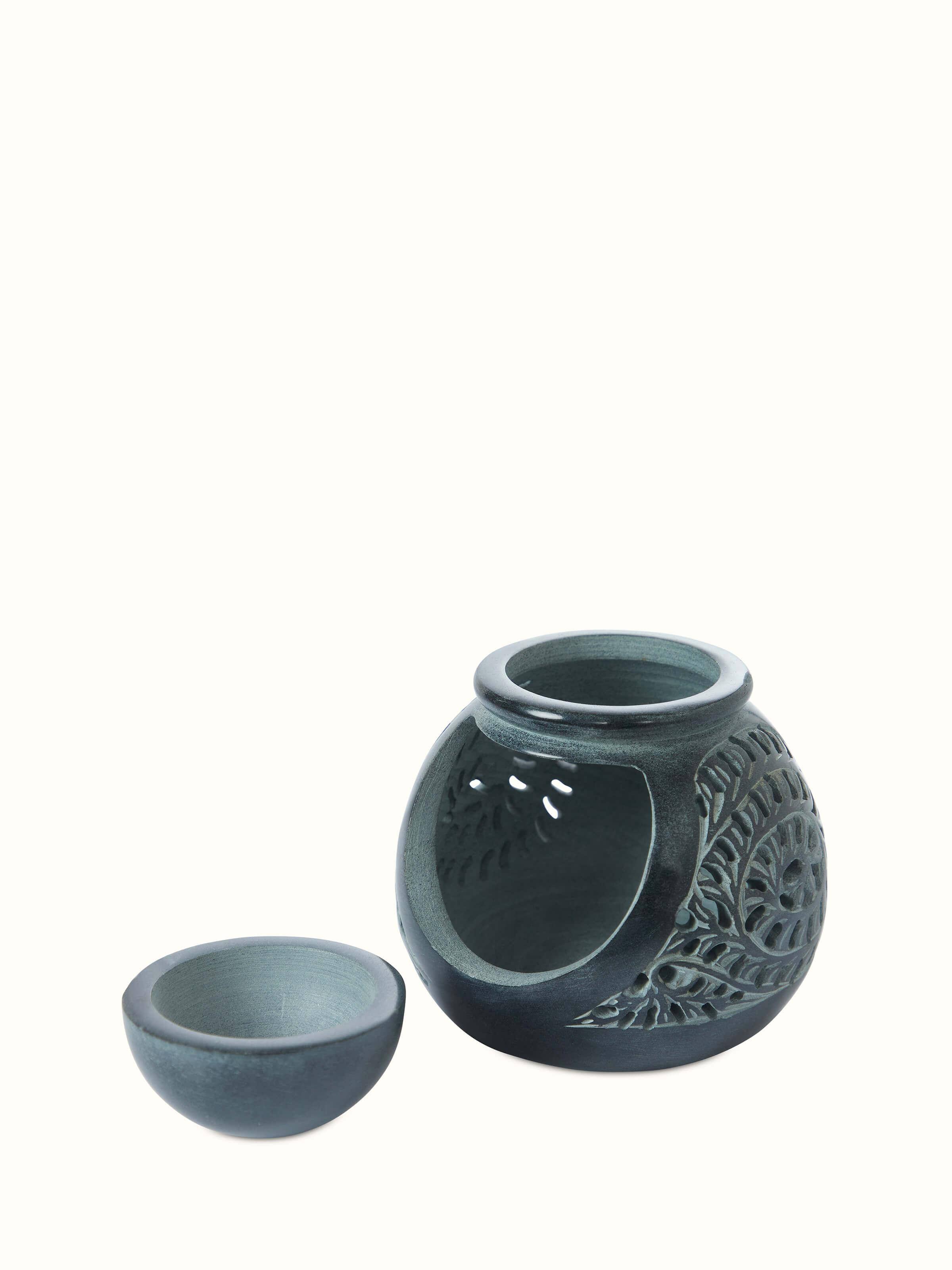 Angled view of Carved soapstone aroma oil burner emphasizing its detailed carvings and functional design