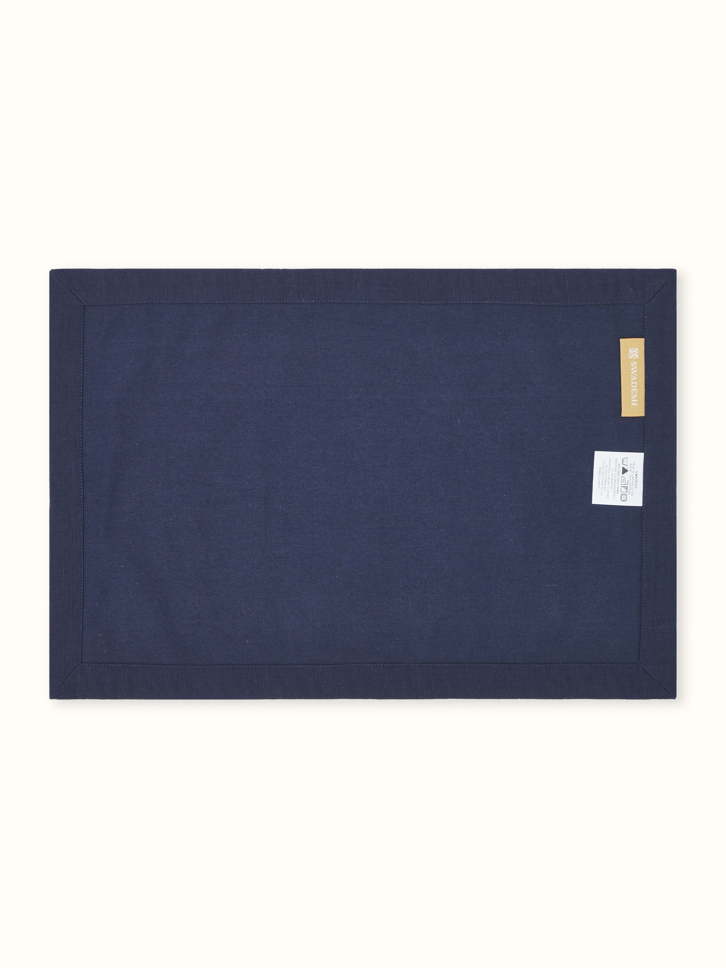 Back side view of Parvat indigo edge stitch linen cotton table mat