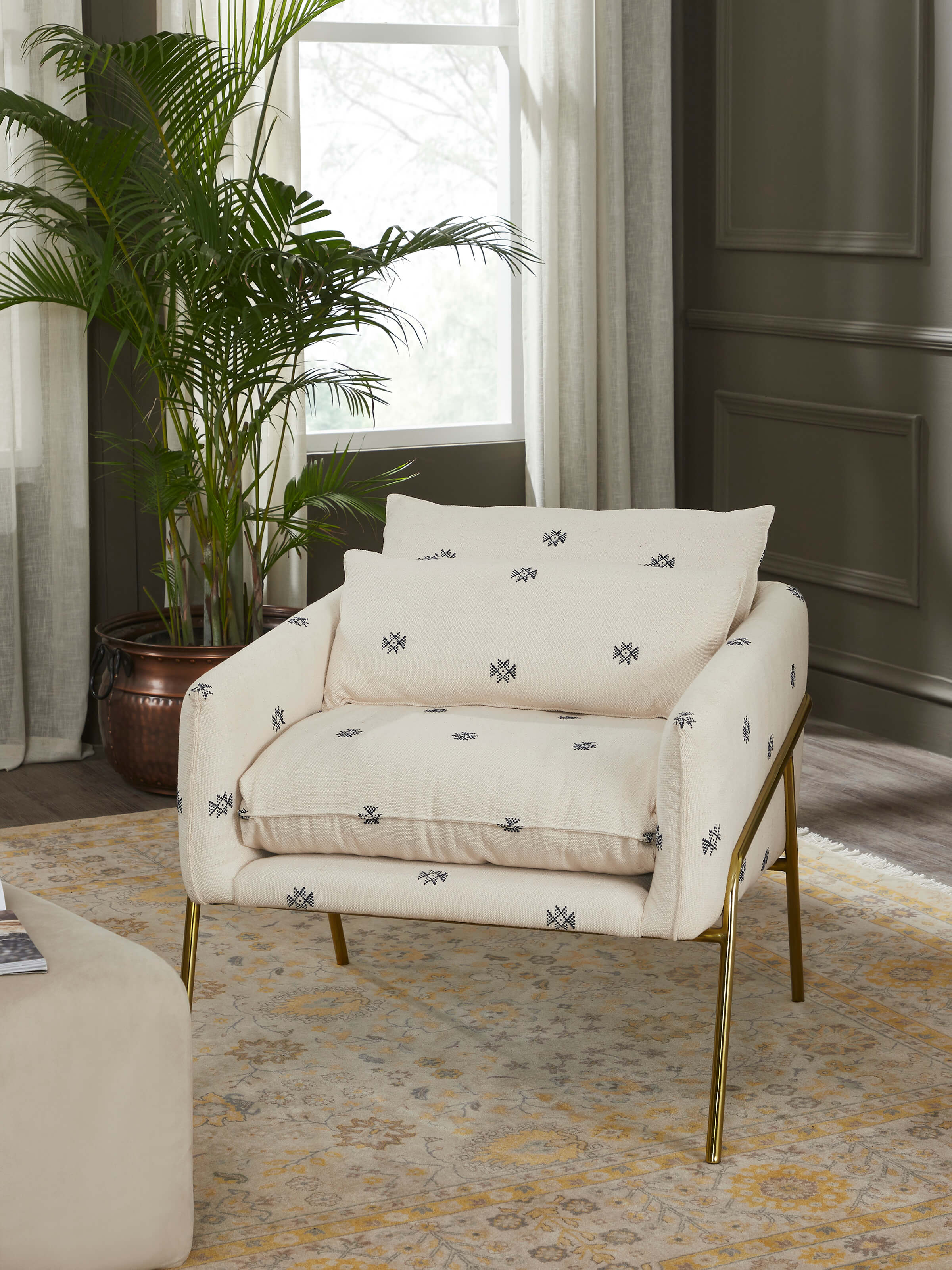 Side view of Upholstered Metal Lounge Chair highlighting its sleek, contemporary design and comfortable seating.