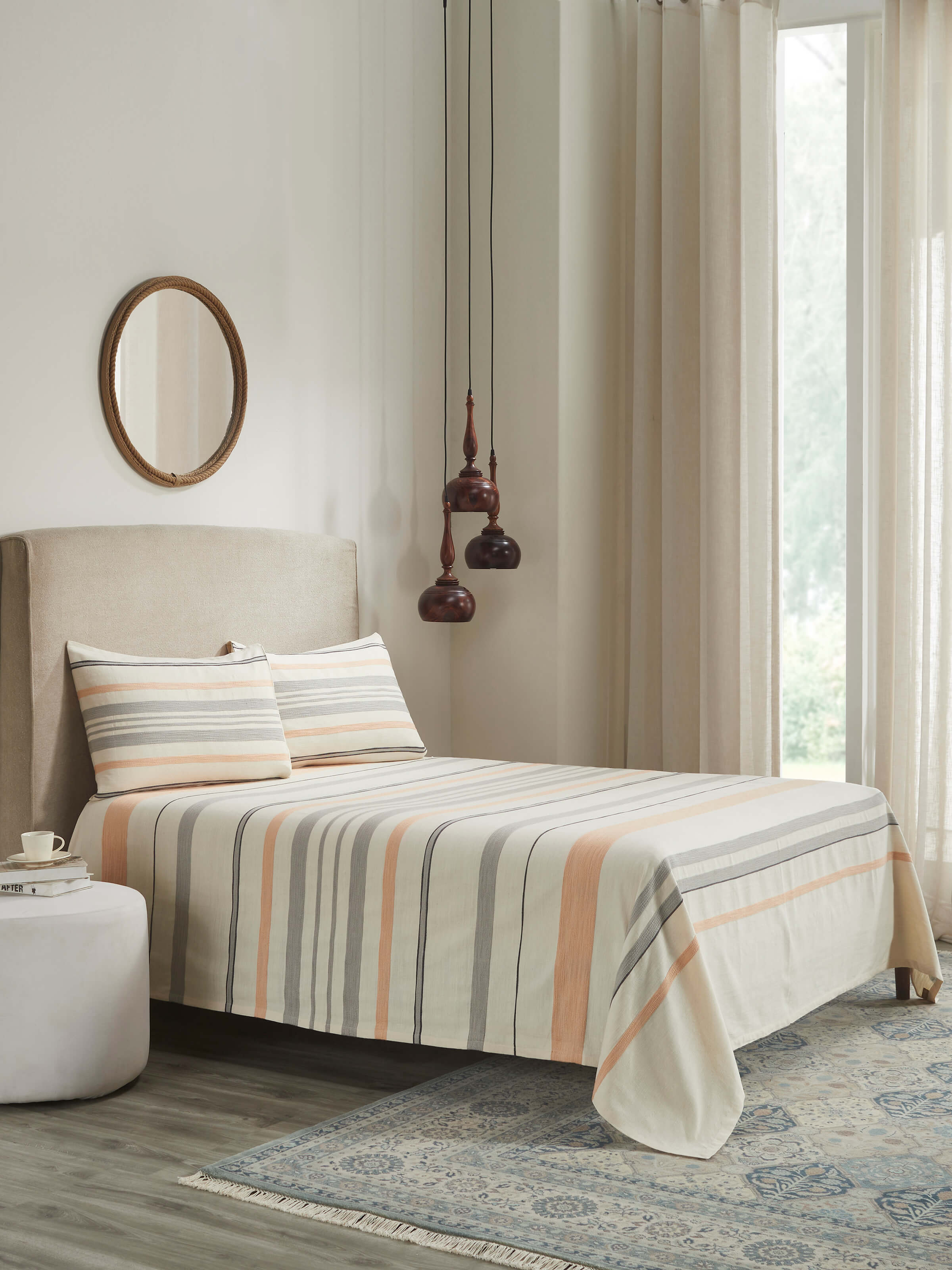 Lifestyle setting showcasing Grey Stripe King-size Bedspread with matching pillowcases for a minimal, elegant look.