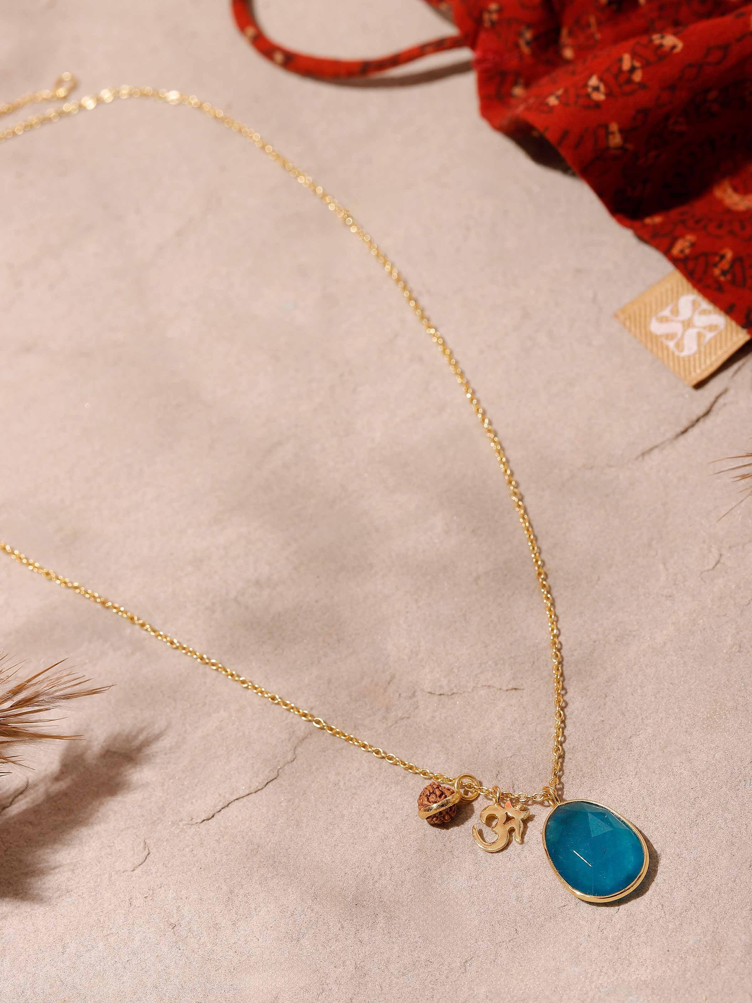 Side angle of Rudraksha & Rose Quartz Necklace showing delicate Om charm and warm-toned quartz beads