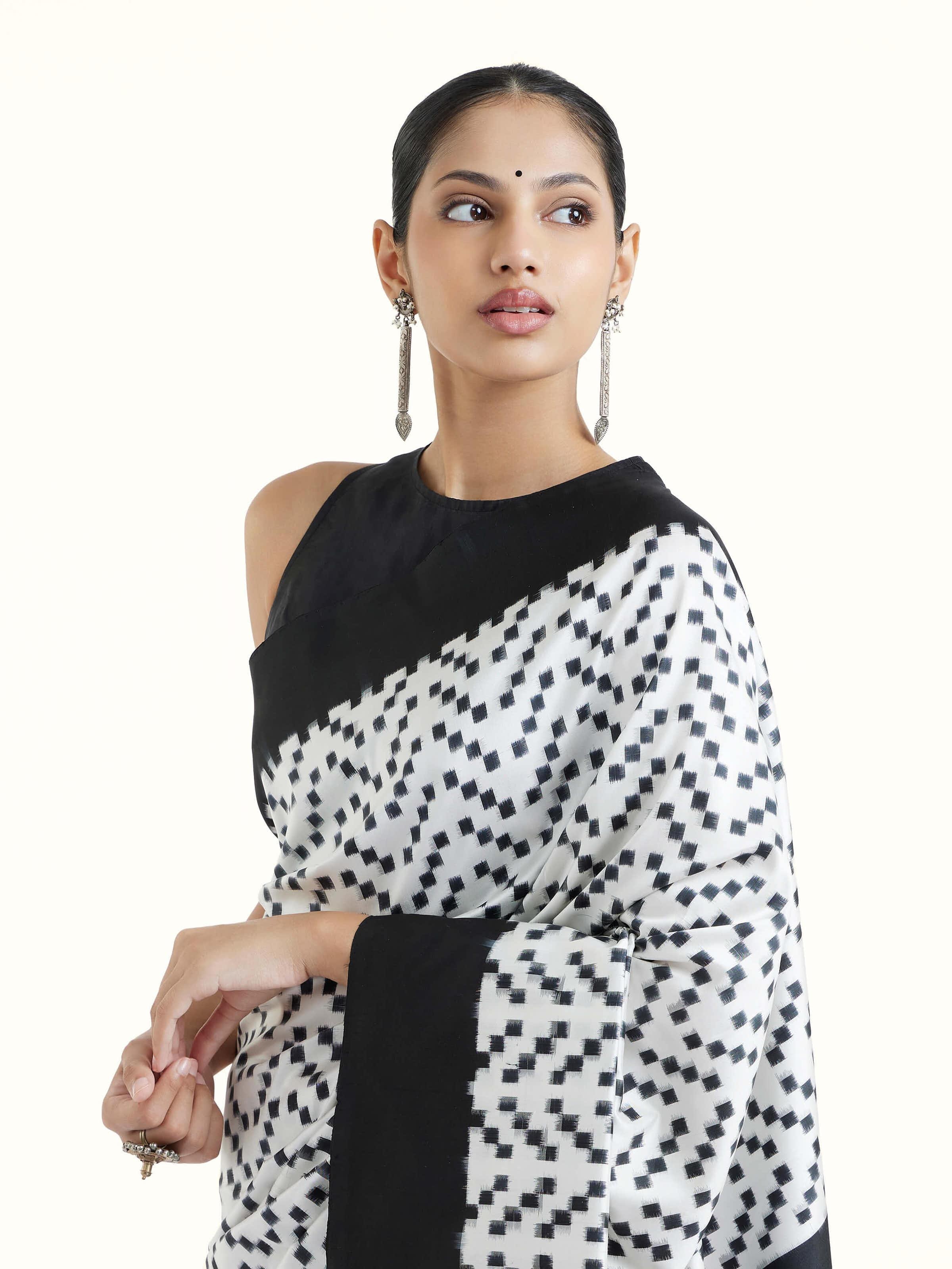 Angled view of black silk double ikat saree highlighting intricate ikat patterns