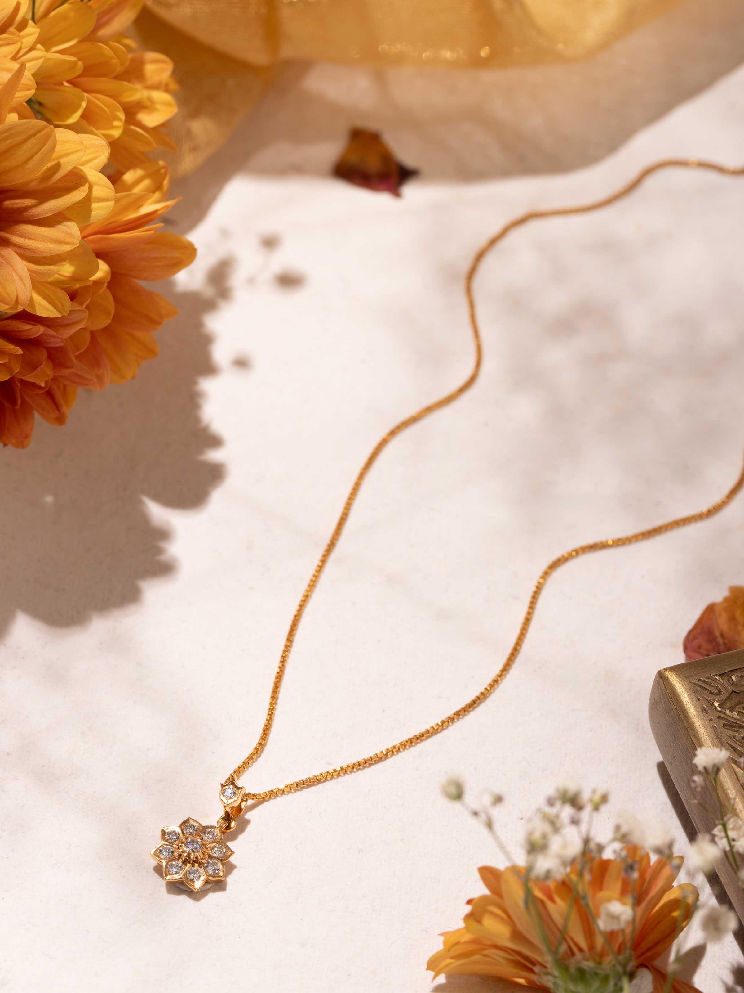Close-up of Close-setting 22 Karat Gold Pendant & Chain by Swadesh highlighting the intricate gold setting and pendant design